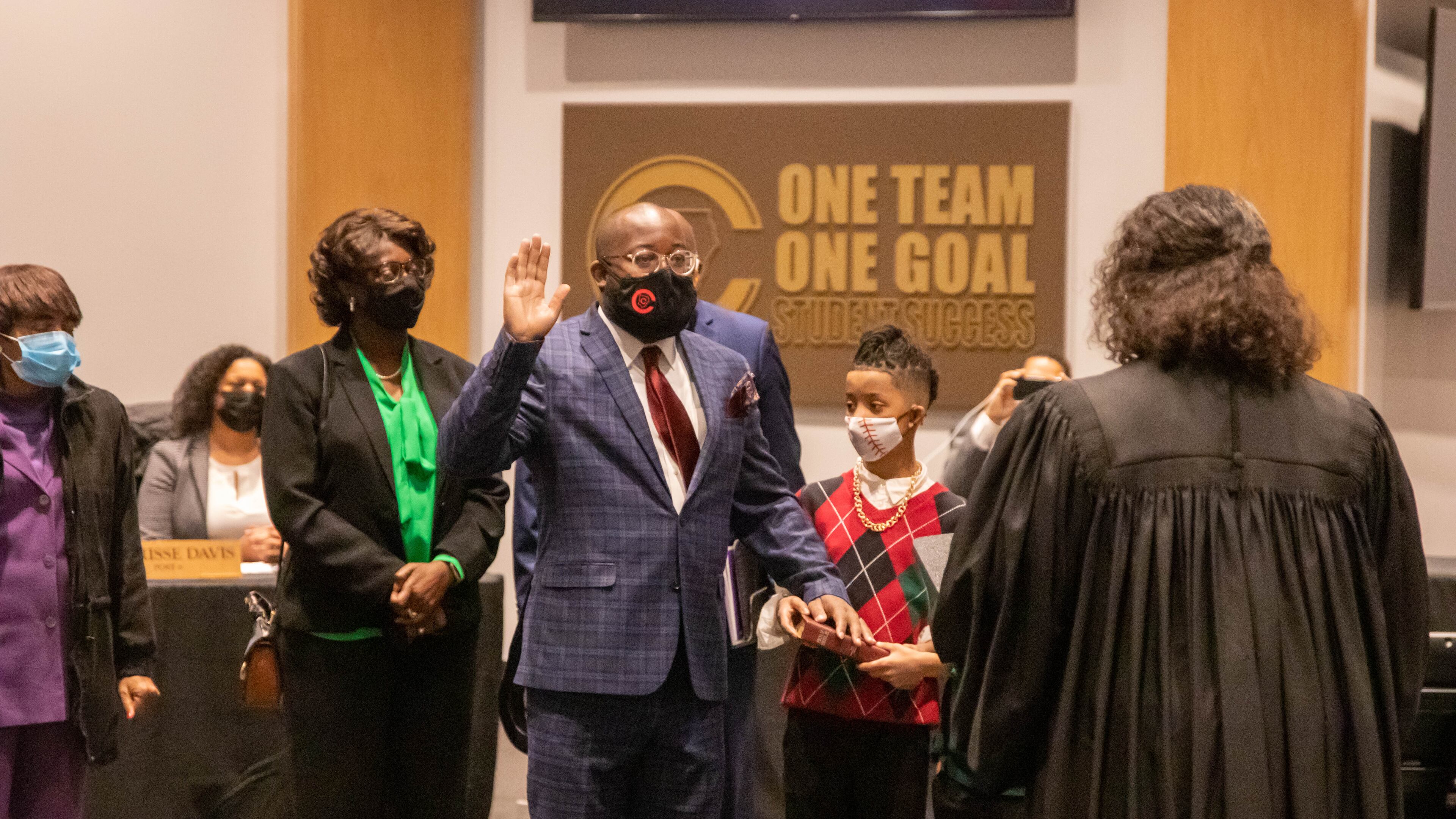 New Cobb County Board of Education member Leroy "Tre" Hutchins takes his oath of office issued by Superior Court Judge Kellie Hill during a called meeting on Thursday. Credit: Cobb County School District.