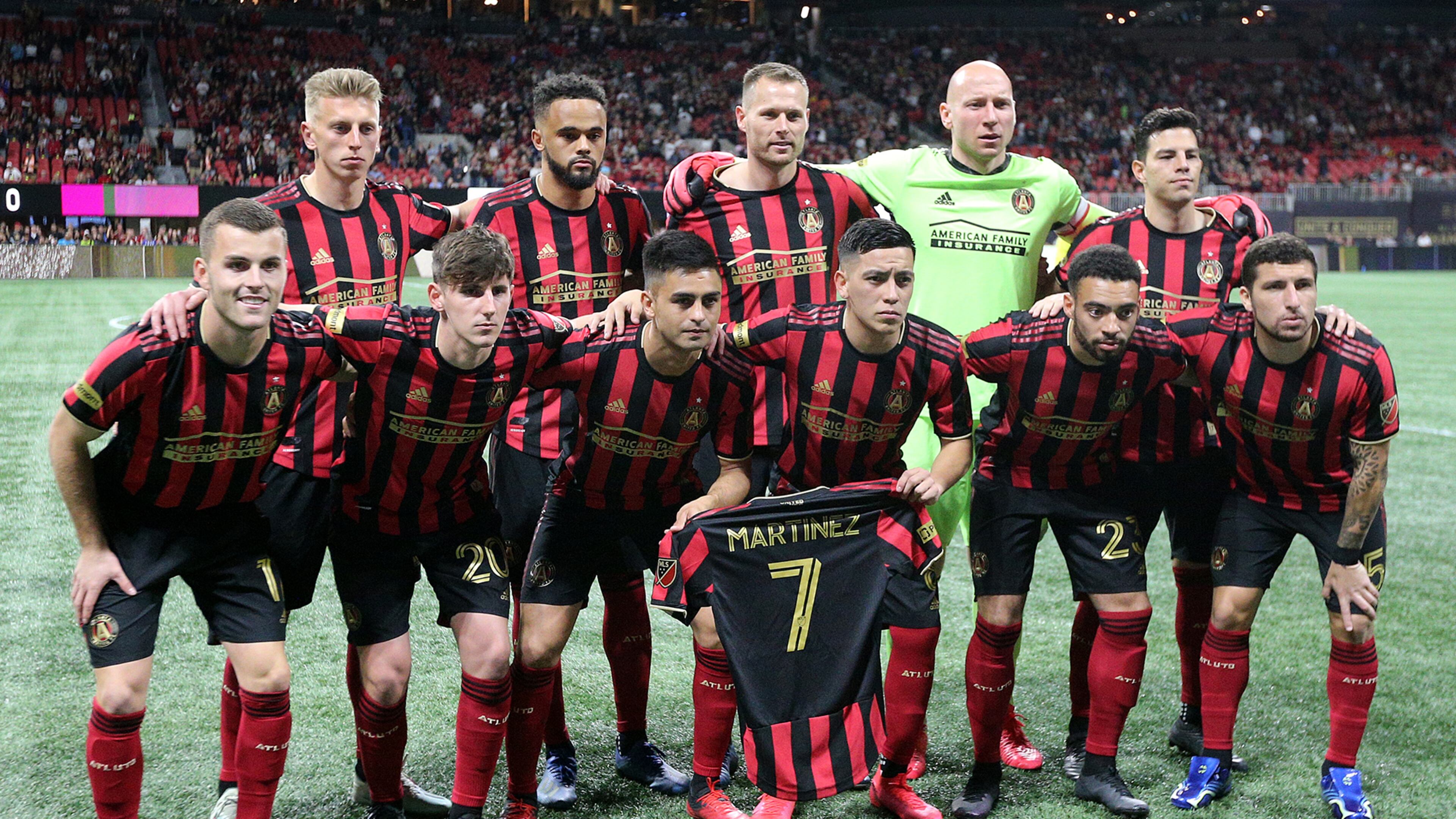 Atlanta United players hold a Martinez jersey as they take the field to play FC Cincinnati in a MLS soccer match on Saturday, March 8, 2020, in Atlanta. Curtis Compton ccompton@ajc.com