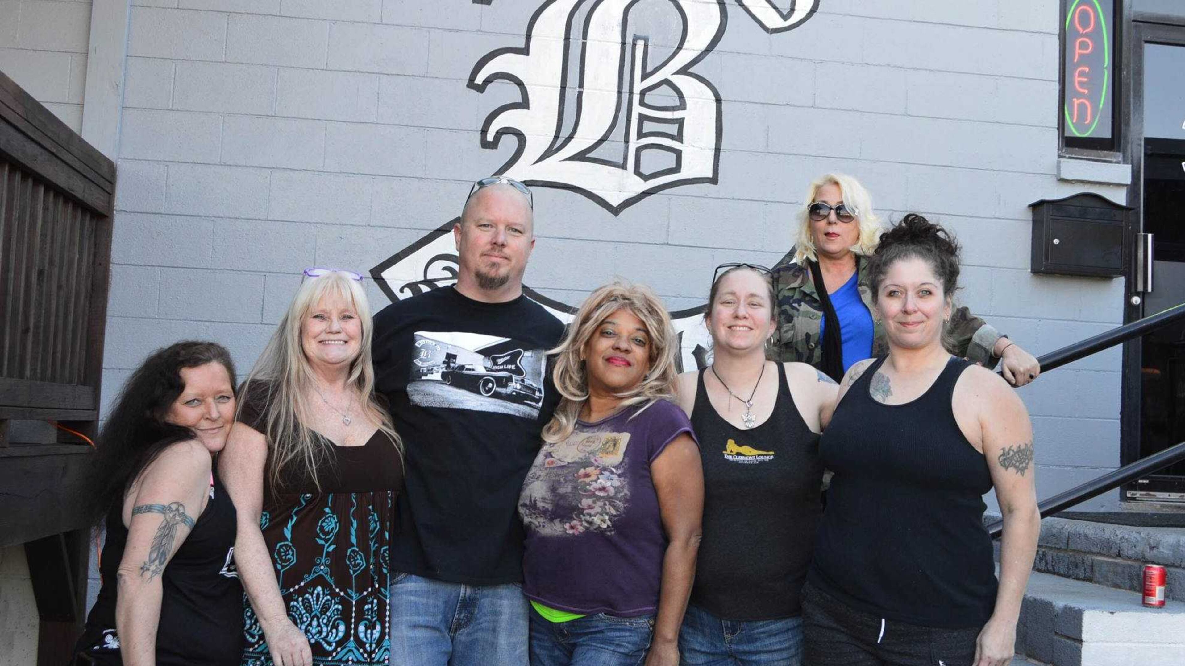 Carlos Bickers, owner of B3 Bar and Grill in Austell, poses with some of the Clermont Lounge's exotic dancers Feb. 26, 2017. They were at B3 for a car wash fundraiser while the iconic Atlanta dive bar undergoes longer-than-expected renovations.