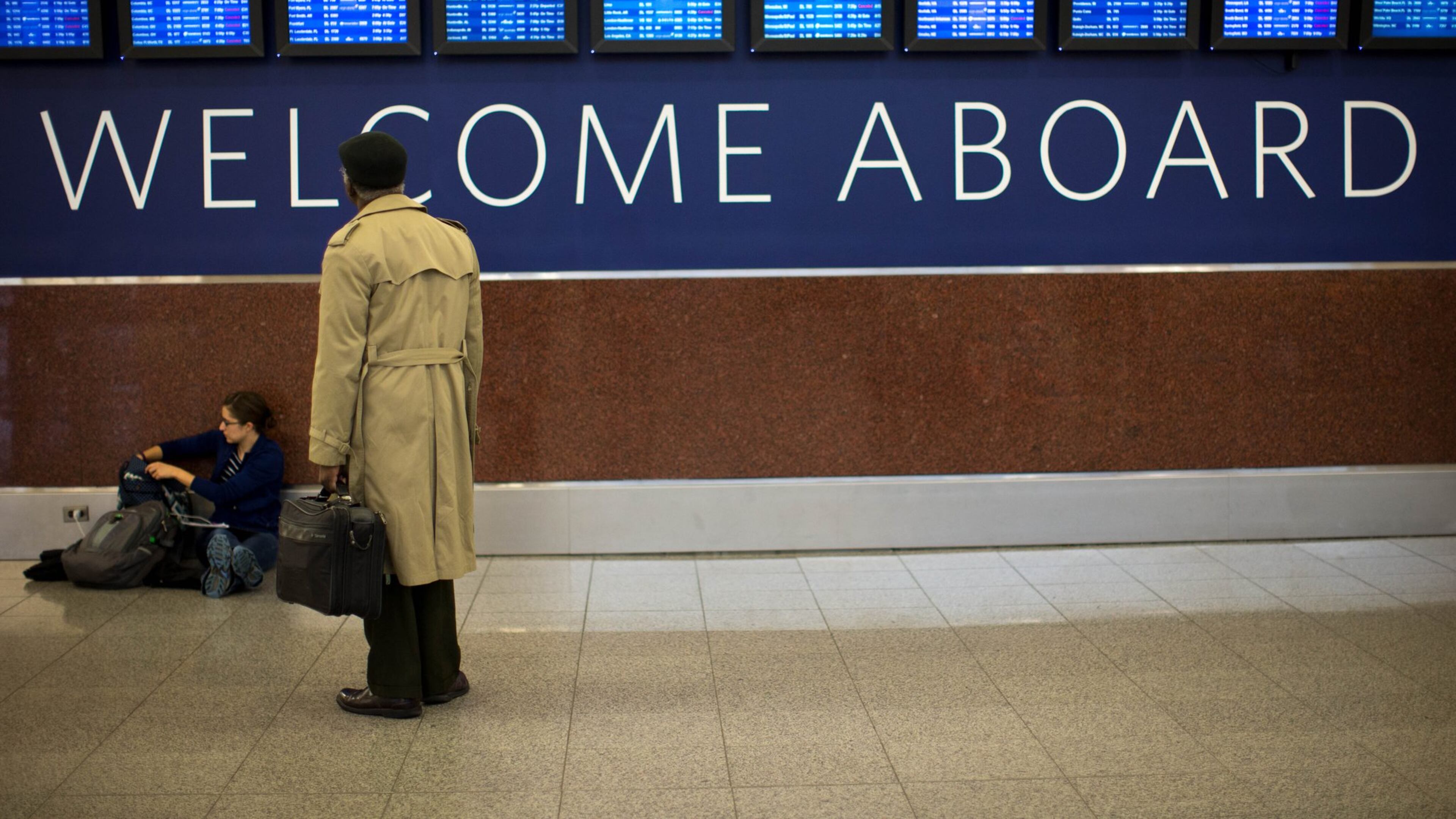 A passenger checks out the Delta departures and arrivals board at Hartsfield-Jackson earlier this month. About 750 people spent the night on concourses after Sunday evening’s computer system outage, an airport spokesman said. BRANDEN CAMP/SPECIAL
