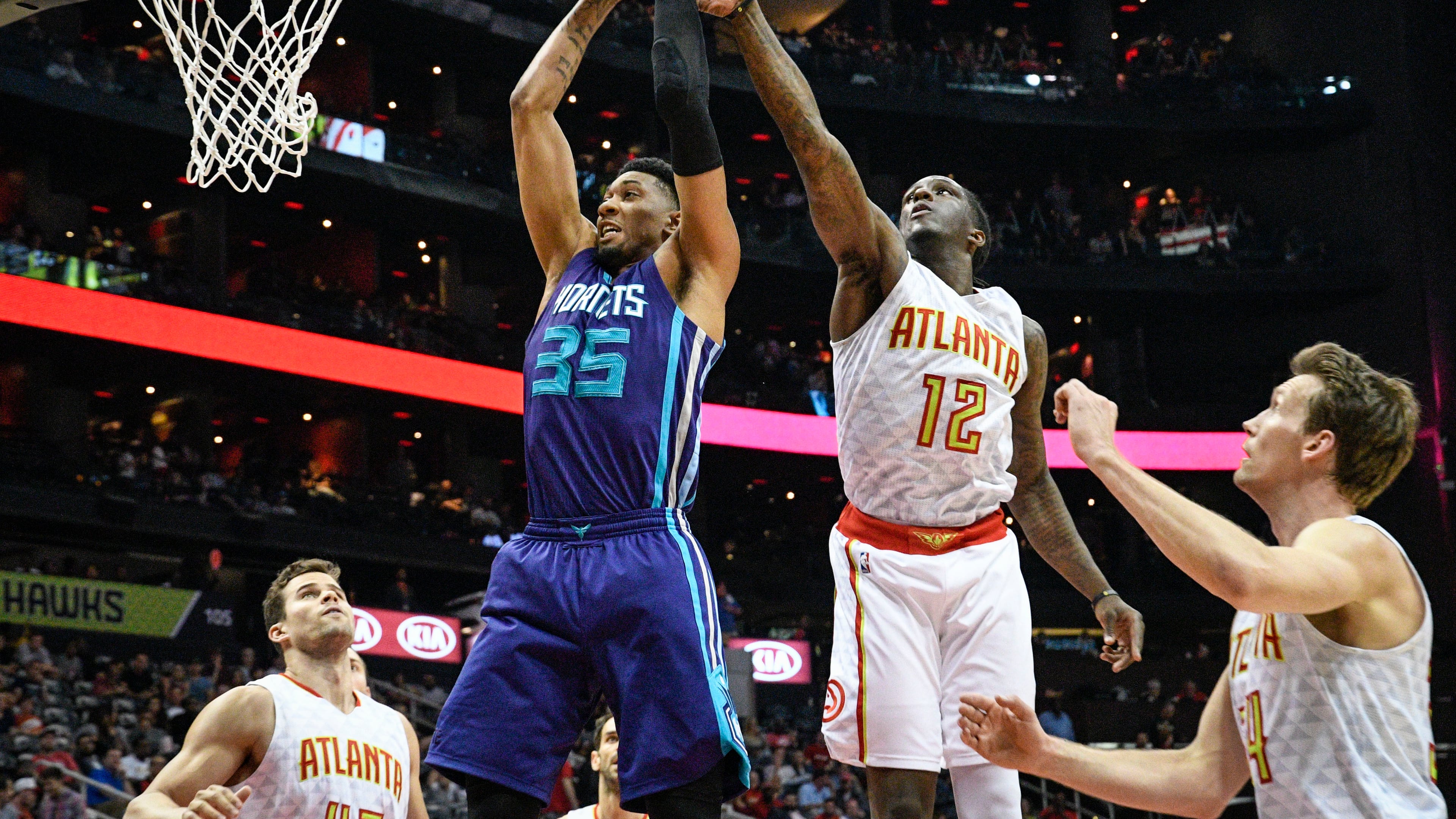 Charlotte Hornets forward Christian Wood (35) and Atlanta Hawks forward Taurean Prince (12) vie for a rebound during an NBA basketball game, Tuesday, April 11, 2017, in Atlanta. (AP Photo/John Amis)