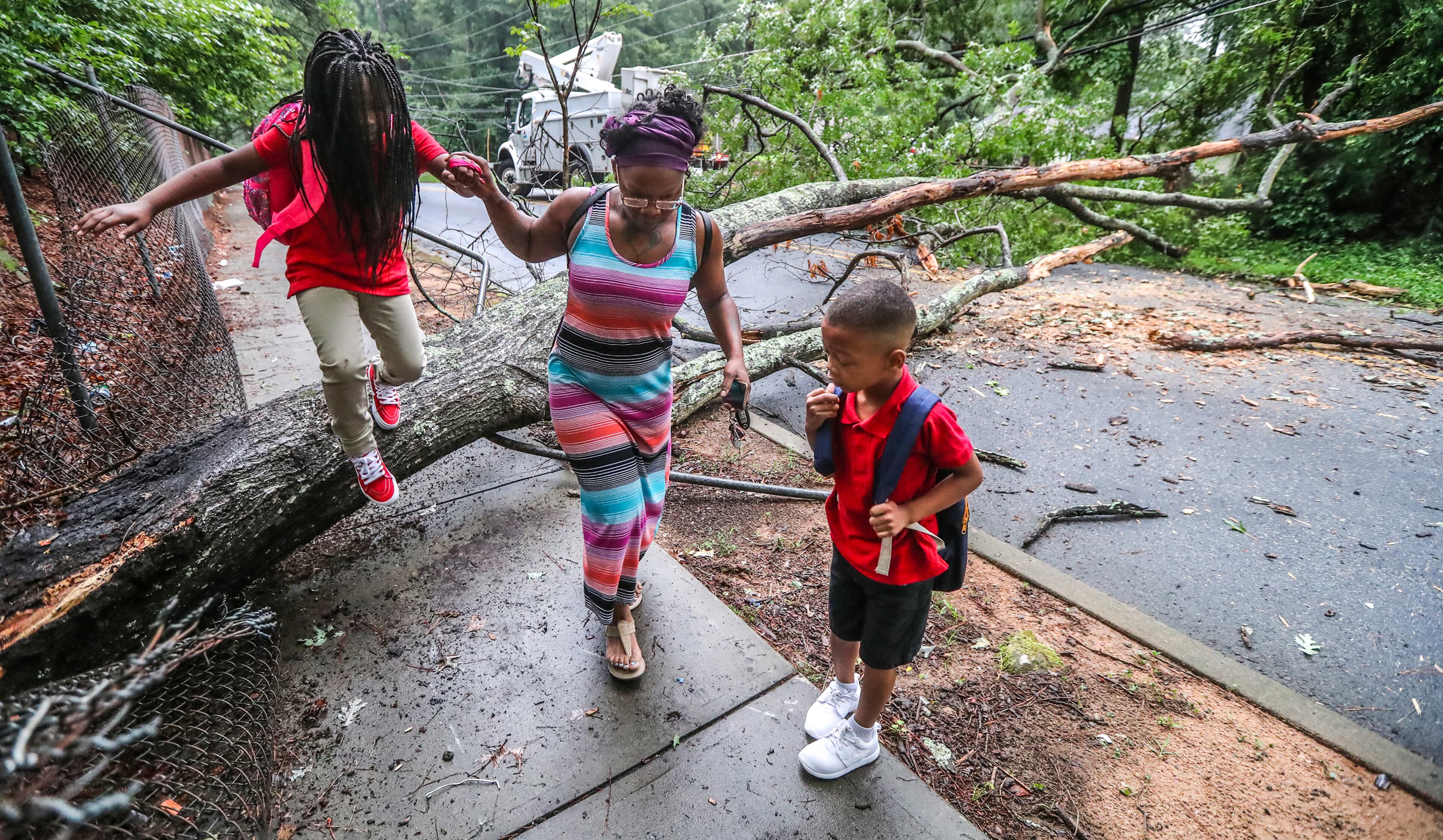 SOGGY WEEK: Atlanta: On the first day of school, a parent who declined to provide her name guided her children over a downed tree that fell across Childress Drive that was closed near Panther Trail in Atlanta on Wednesday, August 1, 2018 after trees and wires came down in an overnight storm.â Traffic signals in the area were not working as well. It was the first day of school for children in Atlanta A flash flood watch by the National Weather Service has been extended into Friday morning. Thursday is the most likely rain day for rain this week, according to Channel 2. Rain chances decrease to 60 percent on Friday before drying out for the weekend. ìThe rain chances come down slightly so more dry periods on Sunday than the rest of this week, certainly,î Channel 2 Action News meteorologist Karen Minton said. Sunday has a low 30 percent chance of scattered storms. The bad weather is thanks to a duo of storm systems over the Atlantic Ocean and the Midwest. A Bermuda high, which is a semi-permanent area of high pressure over the Bermuda area during the summer, is pumping moisture north along the Eastern coastline, Channel 2 chief meteorologist Glenn Burns said.â On the opposite side, an area of low pressure is over the Midwest, moving gulf moisture north through Georgia, he said. JOHN SPINK/JSPINK@AJC.COM