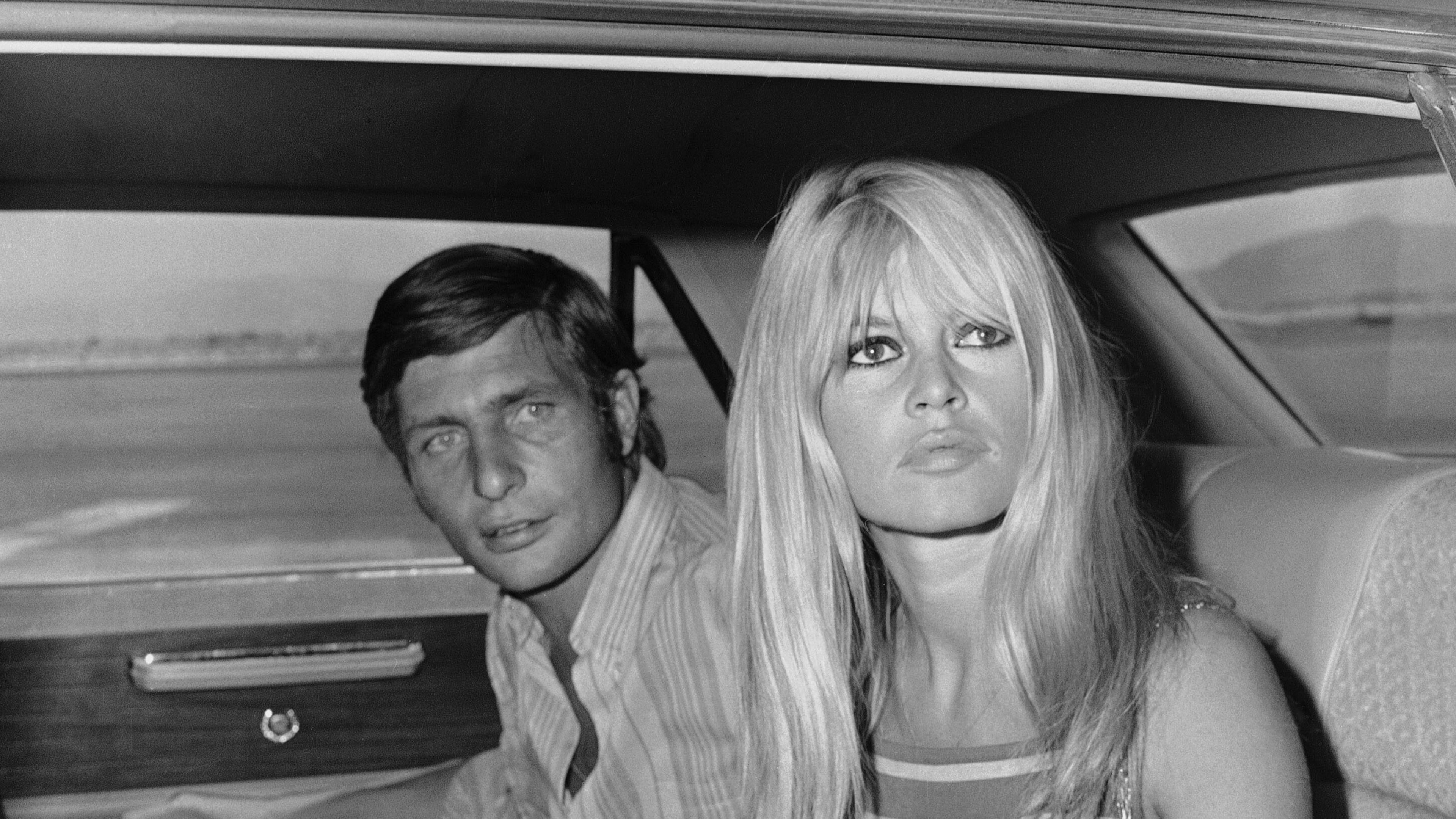 FILE - French film actress Brigitte Bardot and her husband Gunter Sachs pose just before boarding a chartered airplane on their honeymoon in Las Vegas on July 14, 1966. (AP Photo/David F. Smith, File)