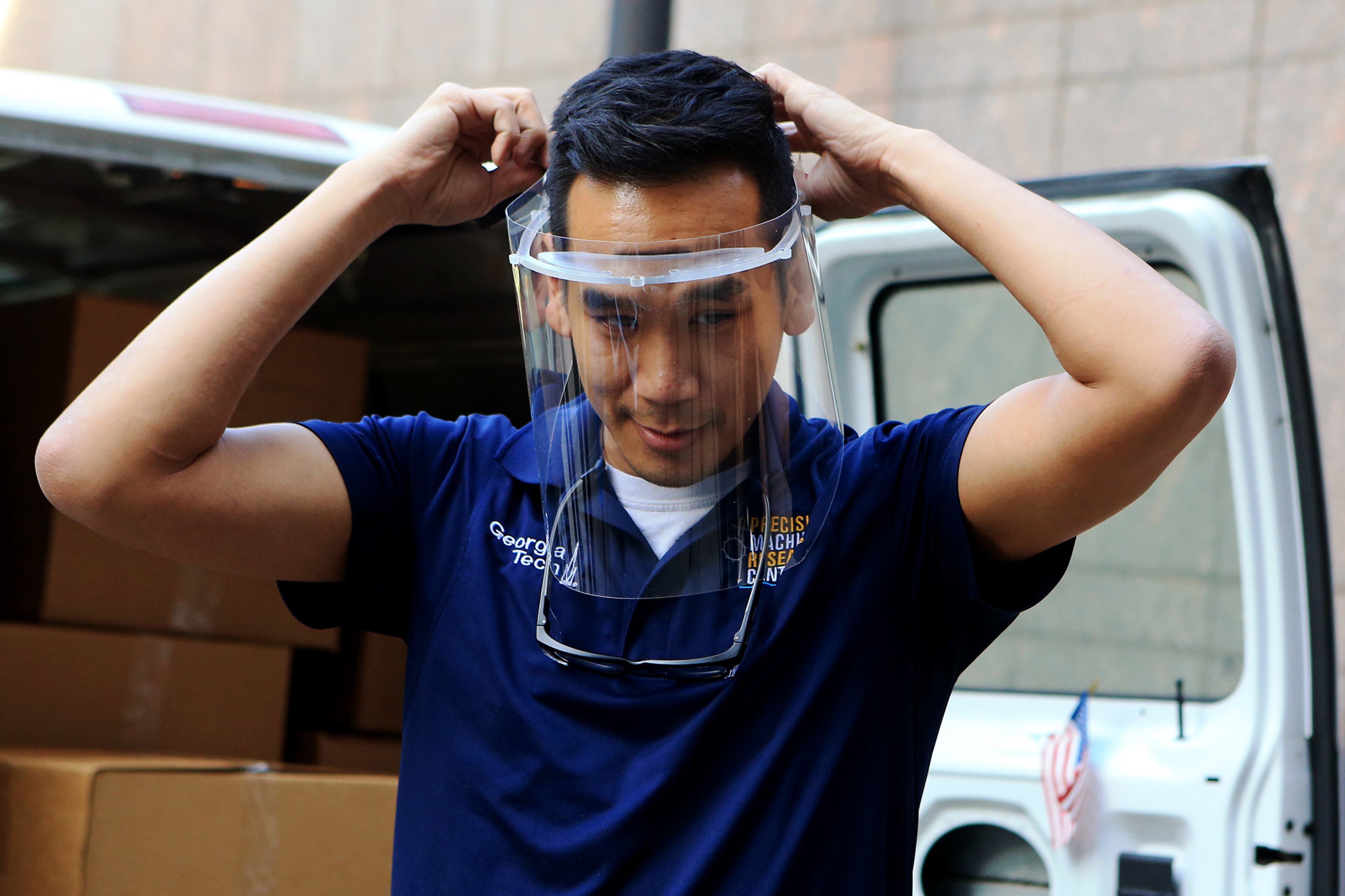 Dr. Christopher Saldana, associate professor at Georgia Tech, demonstrates how to use a donated protective mask on Thursday, March 26, 2020, at Emory Hospital in Atlanta. The masks were created by Saldana and students at Georgia Tech using 3-D technology. (Christina Matacotta, for The Atlanta Journal-Constitution).