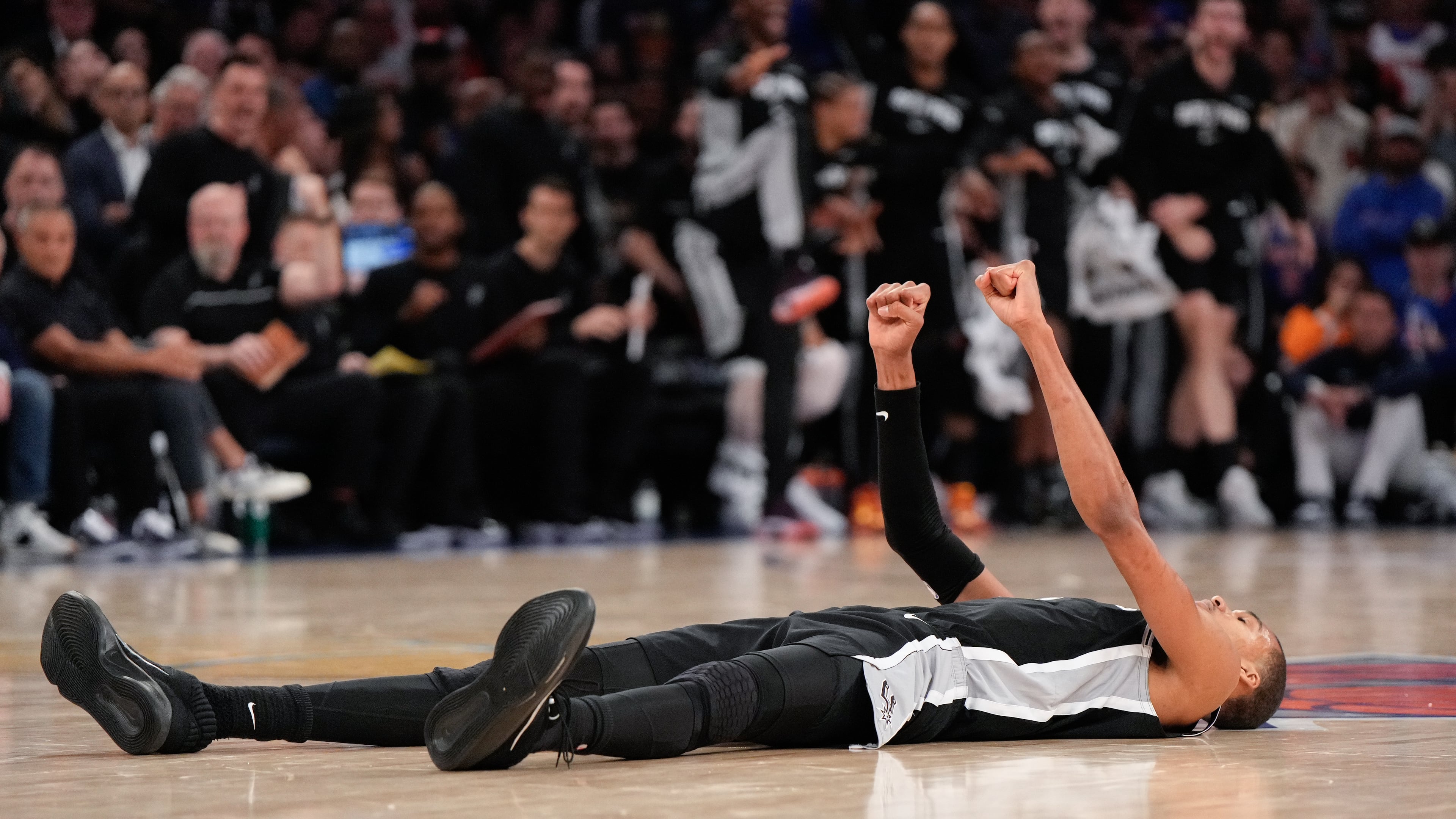 San Antonio Spurs forward Victor Wembanyama lies on the court after a shot during second half of Game 3 of the NBA Finals basketball series against the New York Knicks, Monday, June 8, 2026, in New York. (AP Photo/Ross D. Franklin)