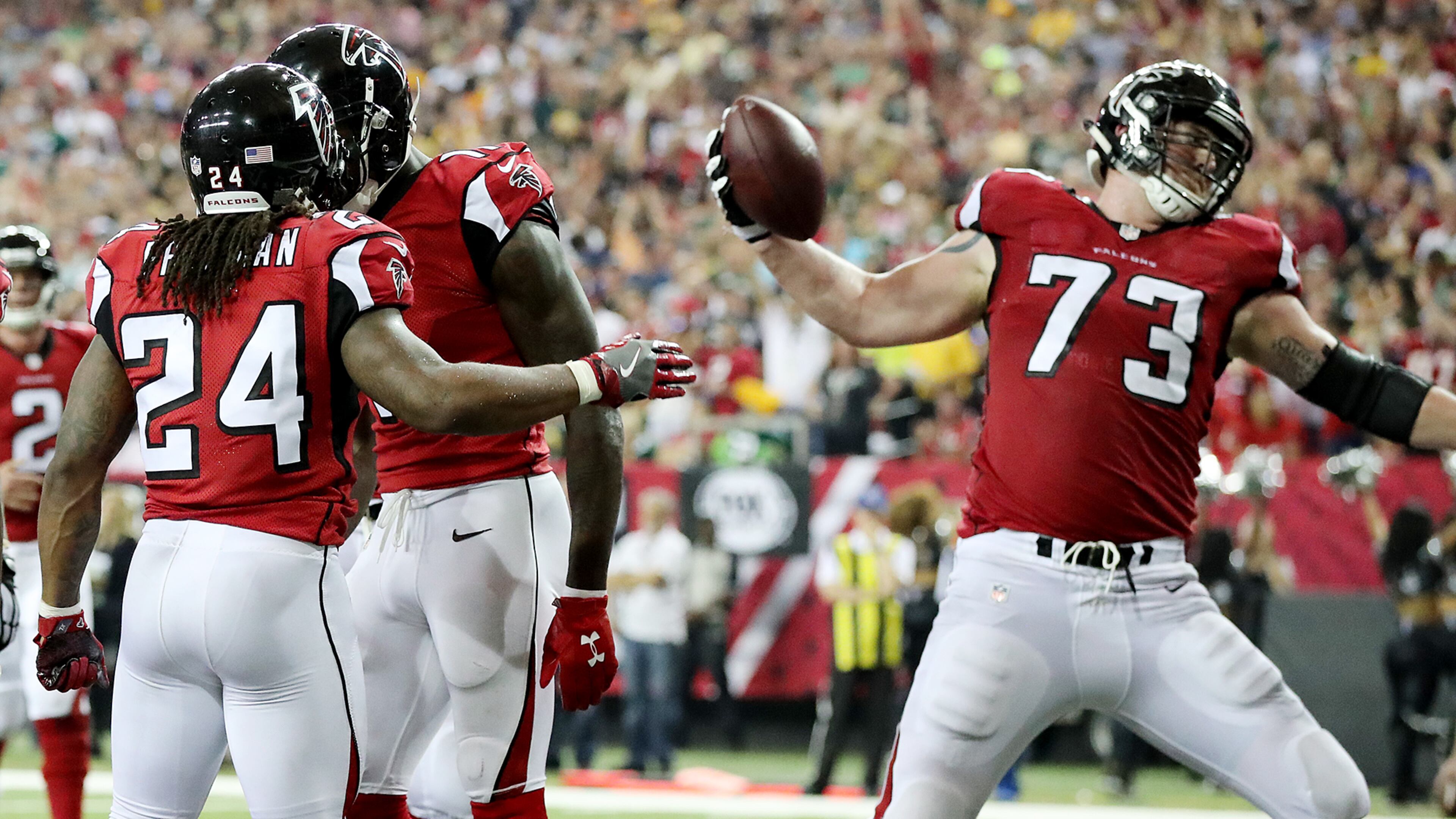 Falcons tackle Ryan Schraeder gladly does the honors, spiking the ball following a Devonta Freeman score. (Curtis Compton /ccompton@ajc.com)
