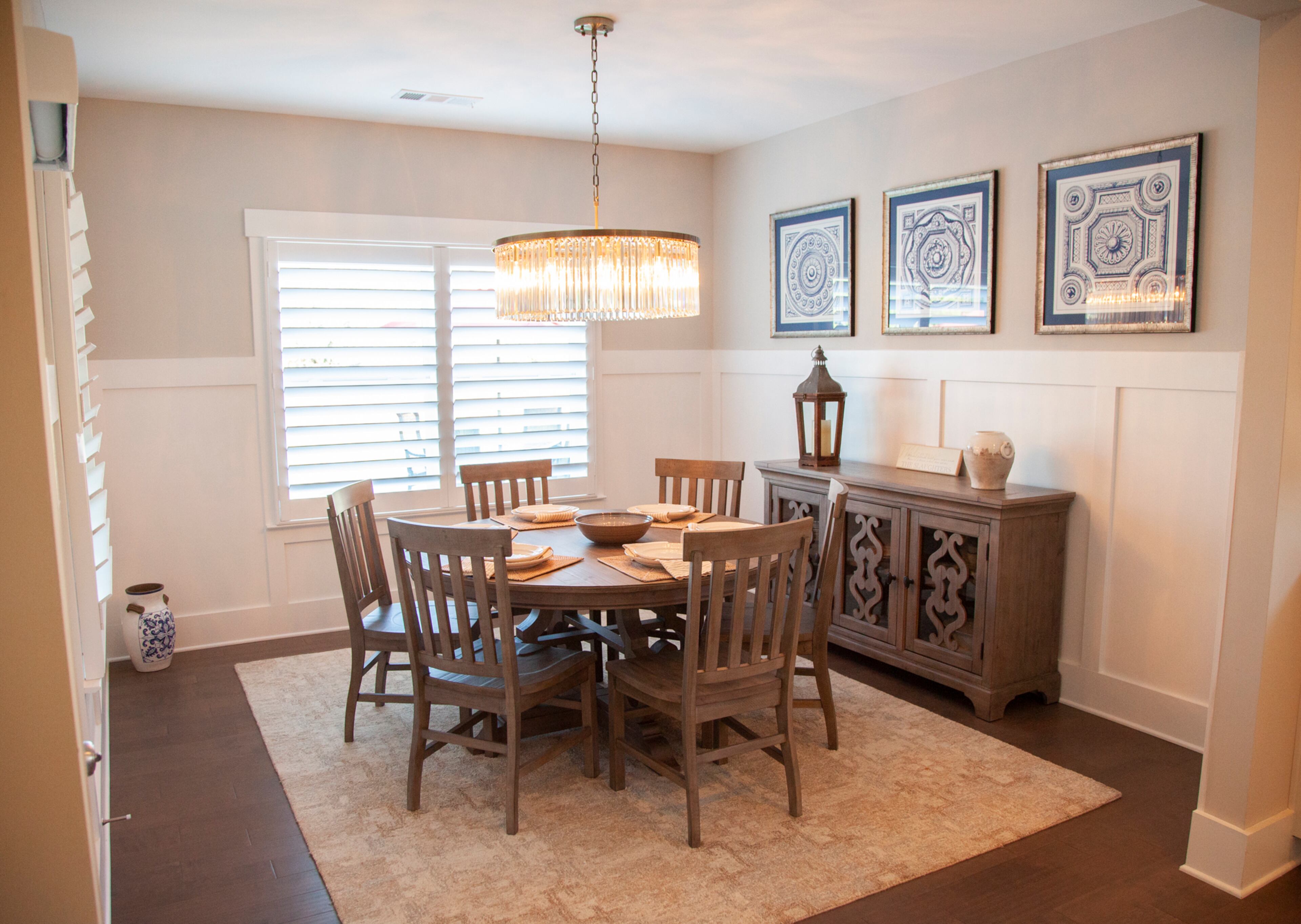 Renee Slaughter said she loves the round dining table from Woodstock Furniture & Mattress Outlet, where she also found the sideboard. The set of framed blue medallions are from Outrageous Interiors. Text by Kat Khoury/Fast Copy News Service. Photo by Reann Huber.