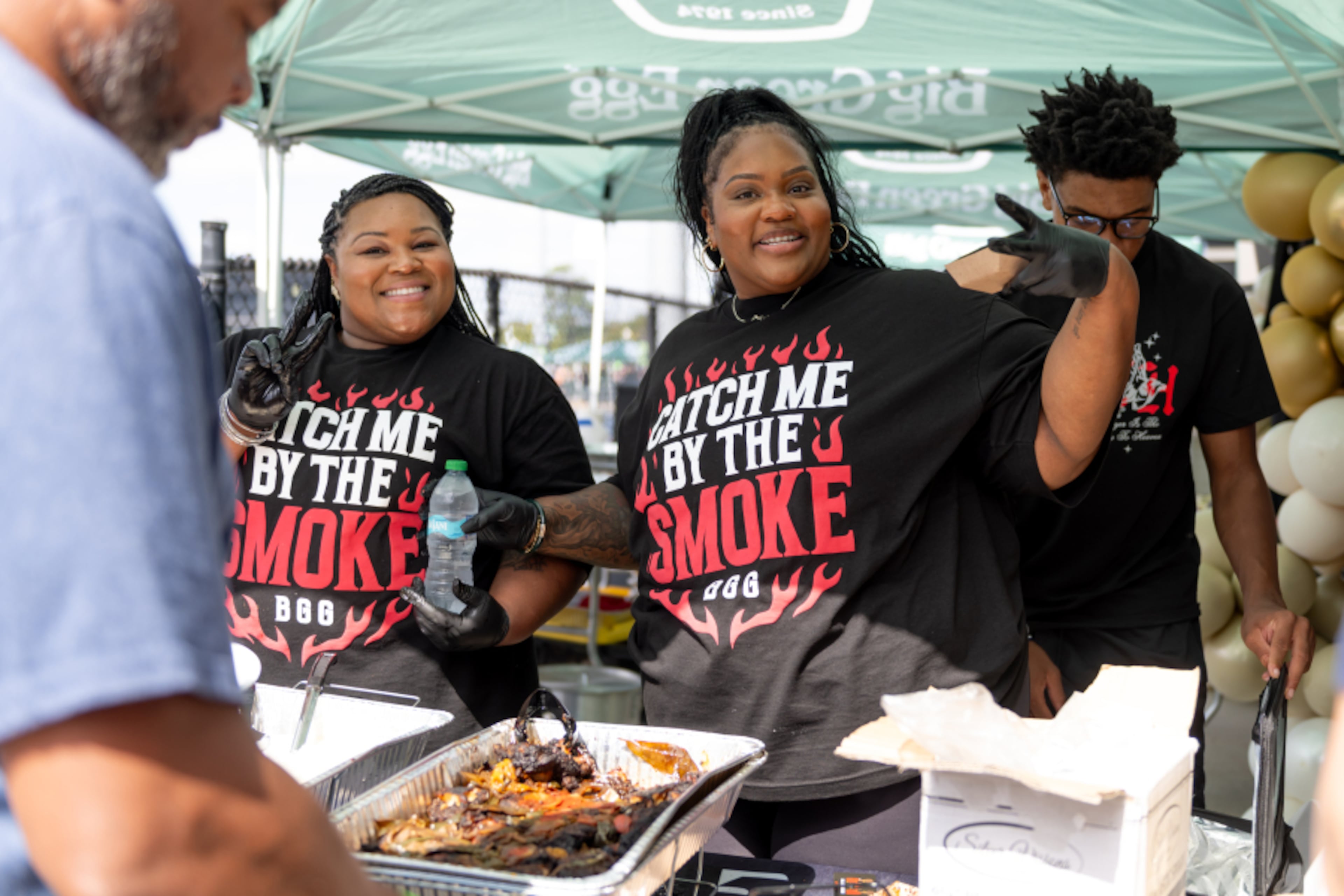 Felicia Jordan (left) and India Glass of Black Girls Grilling cook at EGGtoberfest at Coolray Field in Lawrenceville. The Atlanta-based duo has captured multiple People's Choice Awards at the annual gathering for their live-fire dishes. (Courtesy of Mud Films)