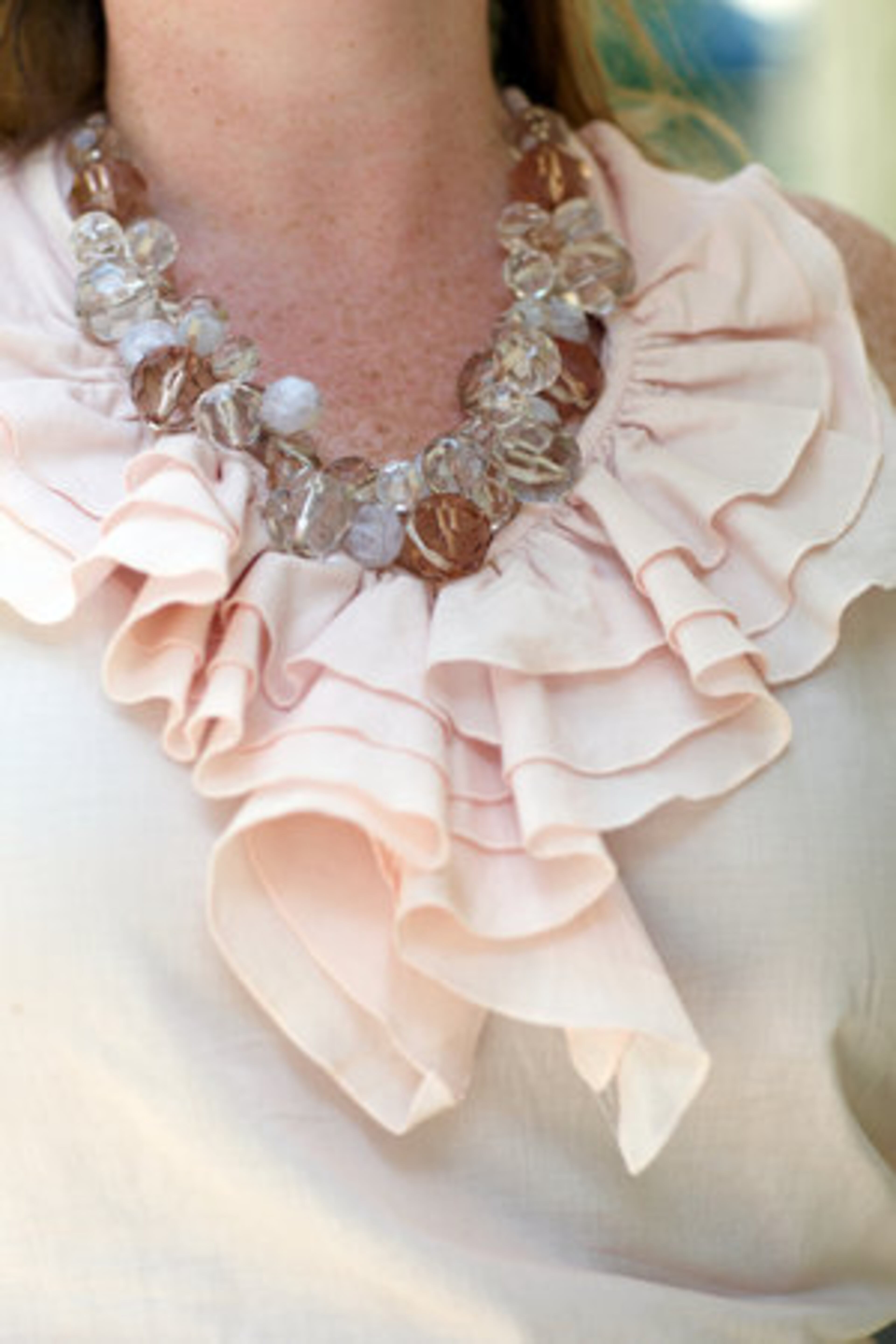 SIGNATURE STYLE: "Classic with a twist." A closer look at the chunky beaded necklace and light pink ruffled blouse, both of which Baber purchased from Ann Taylor Loft.