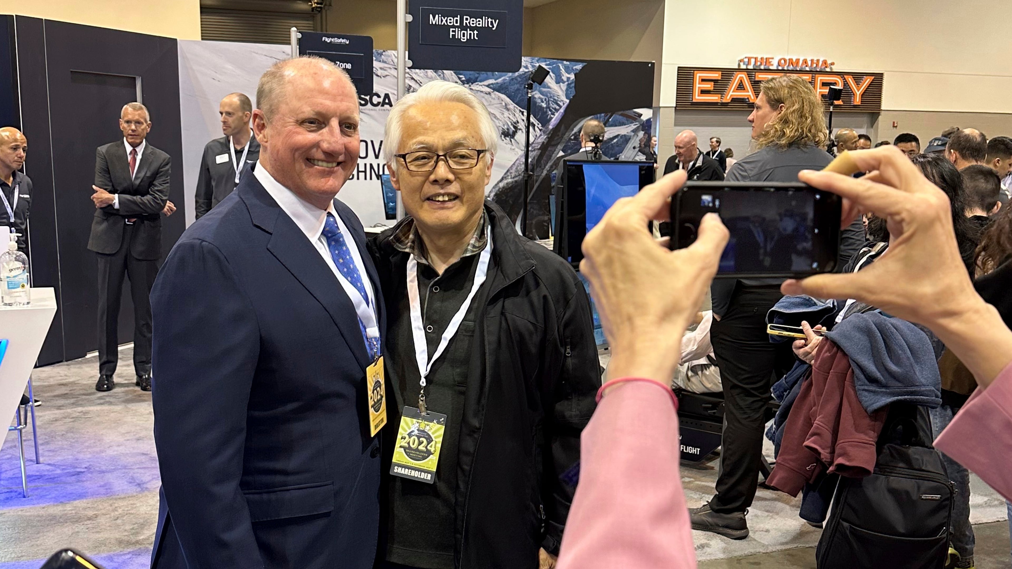FILE - Berkshire Hathaway Vice Chairman Greg Abel poses for pictures with shareholders while touring the booths Berkshires companies set up, May 3, 2024, in Omaha, Neb. (AP Photo/Josh Funk, File)
