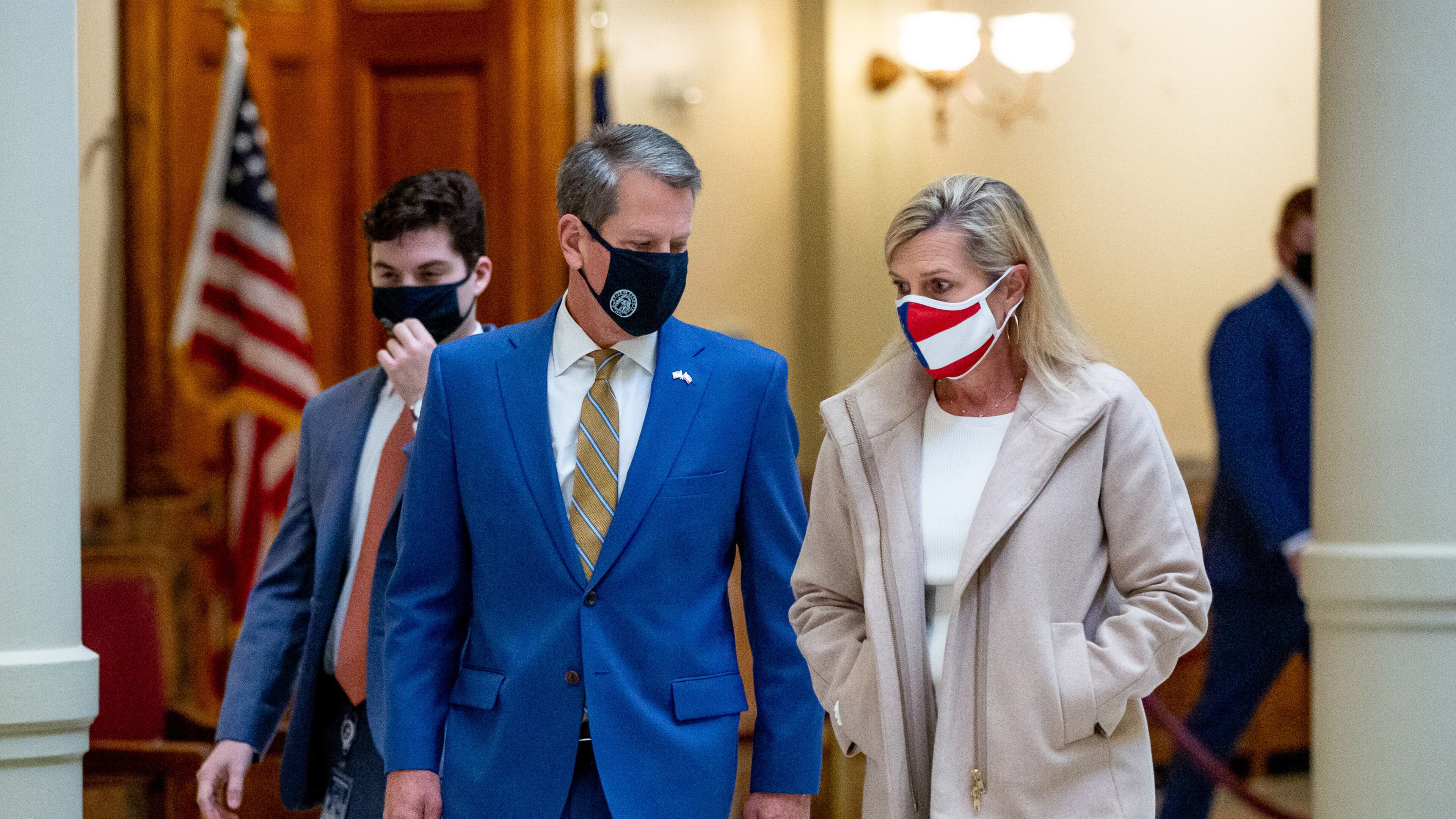 Gov. Brian Kemp and first lady Marty Kemp, shown talking in November before a press conference at the state Capitol, have led efforts targeting human trafficking, including three bills he signed into law on Tuesday. STEVE SCHAEFER / SPECIAL TO THE AJC