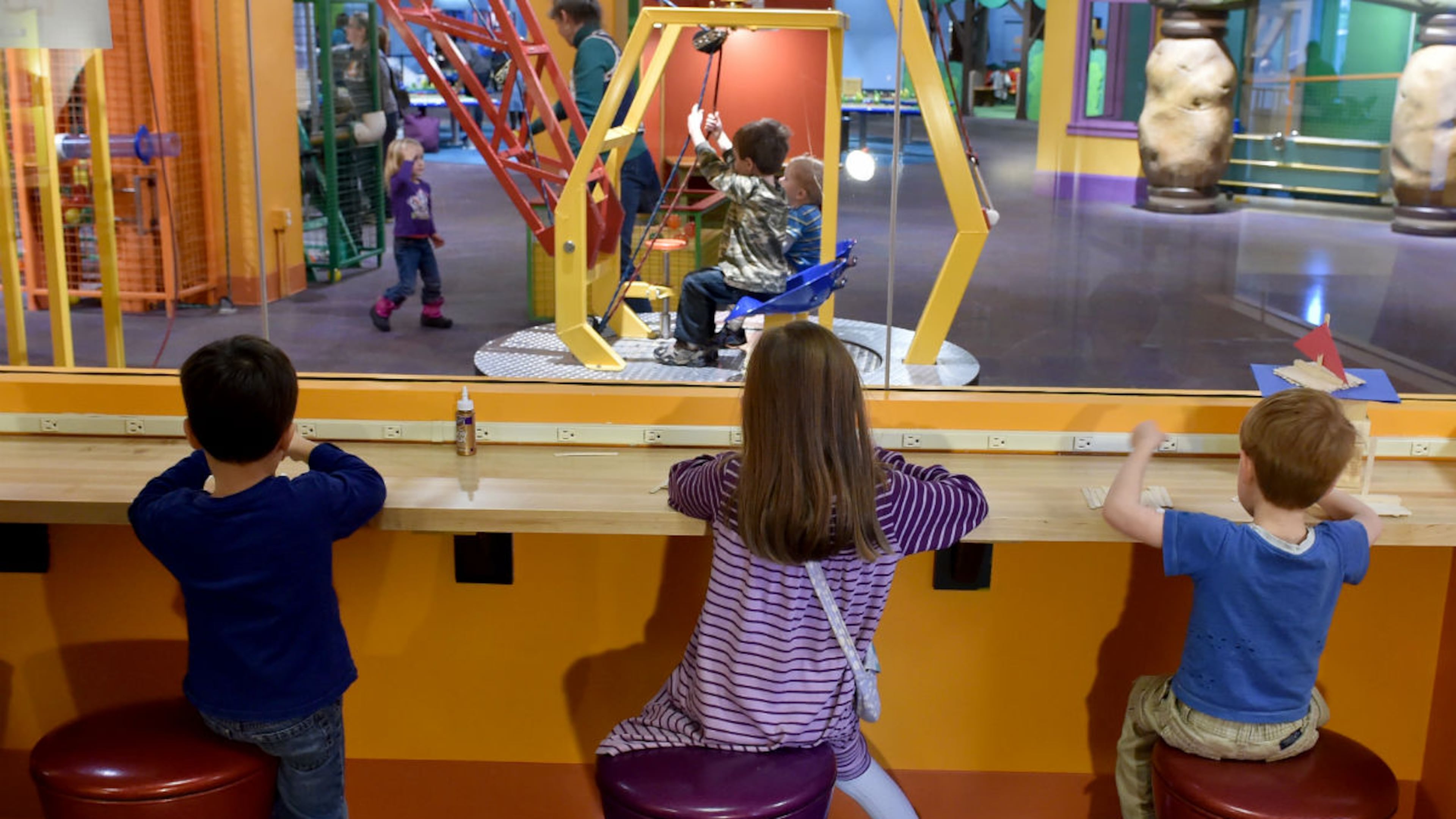 Kids build a project from wood sticks at the The Children's Museum of Atlanta.