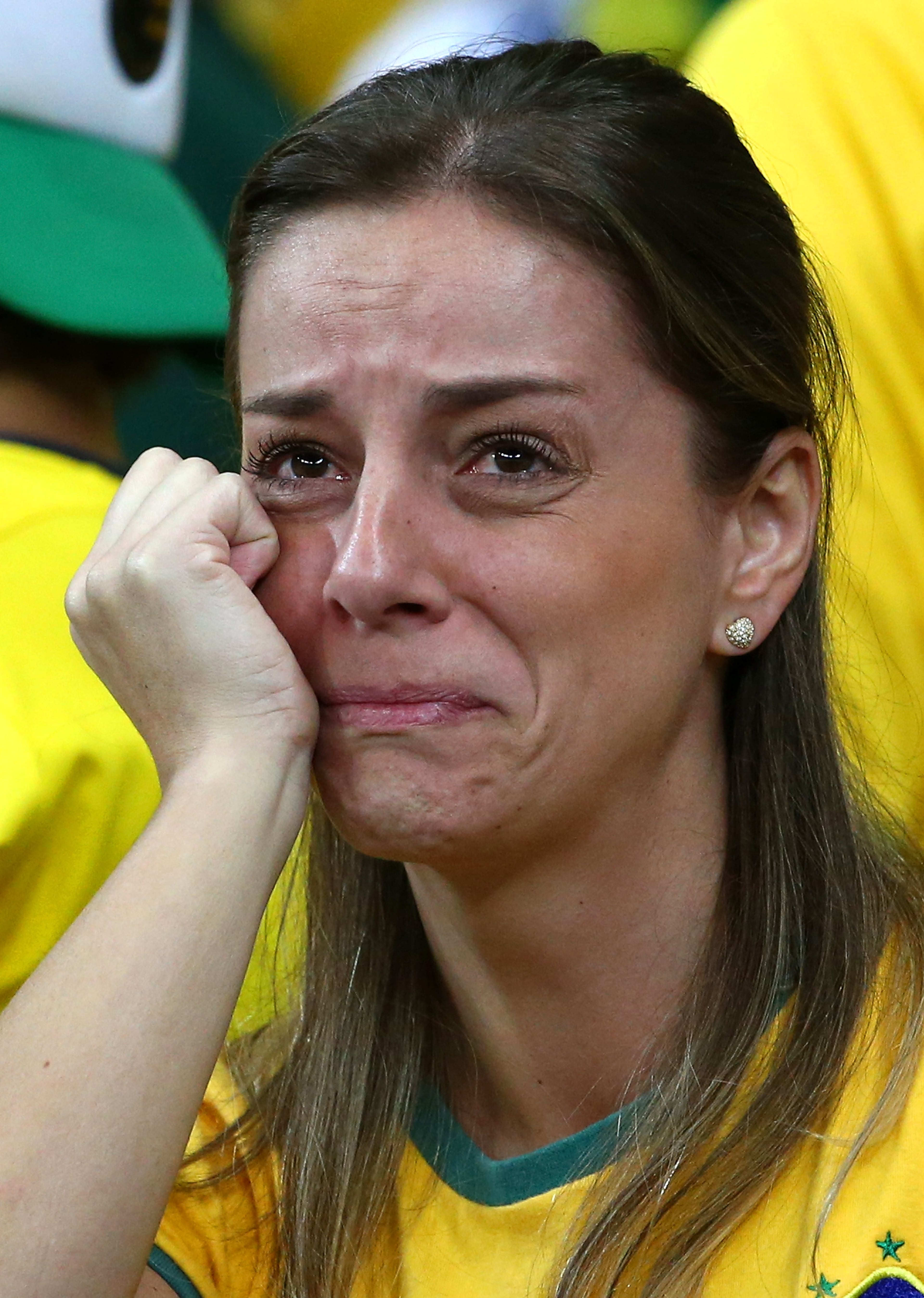 A dejected Brazil fan looks on during the 2014 FIFA World Cup Brazil Semifinal match between Brazil and Germany at Estadio Mineirao on July 8, 2014 in Belo Horizonte, Brazil. (Photo by Robert Cianflone/Getty Images)