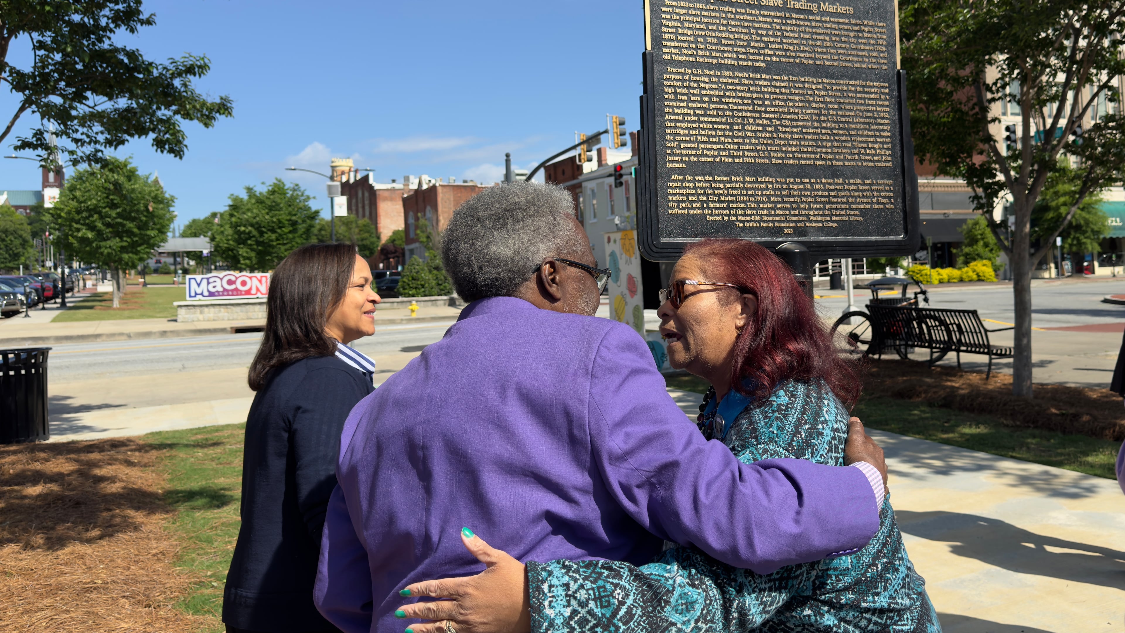 Muriel Jackson, right, embraces Alex Habersham during Monday's unveiling of one of three new Black history markers being installed in downtown Macon, Georgia on Monday, April 22, 2024. Jackson, head of the Genealogical and Historical Room and Middle Georgia Archives at the Washington Memorial Library, wrote the text for the markers.