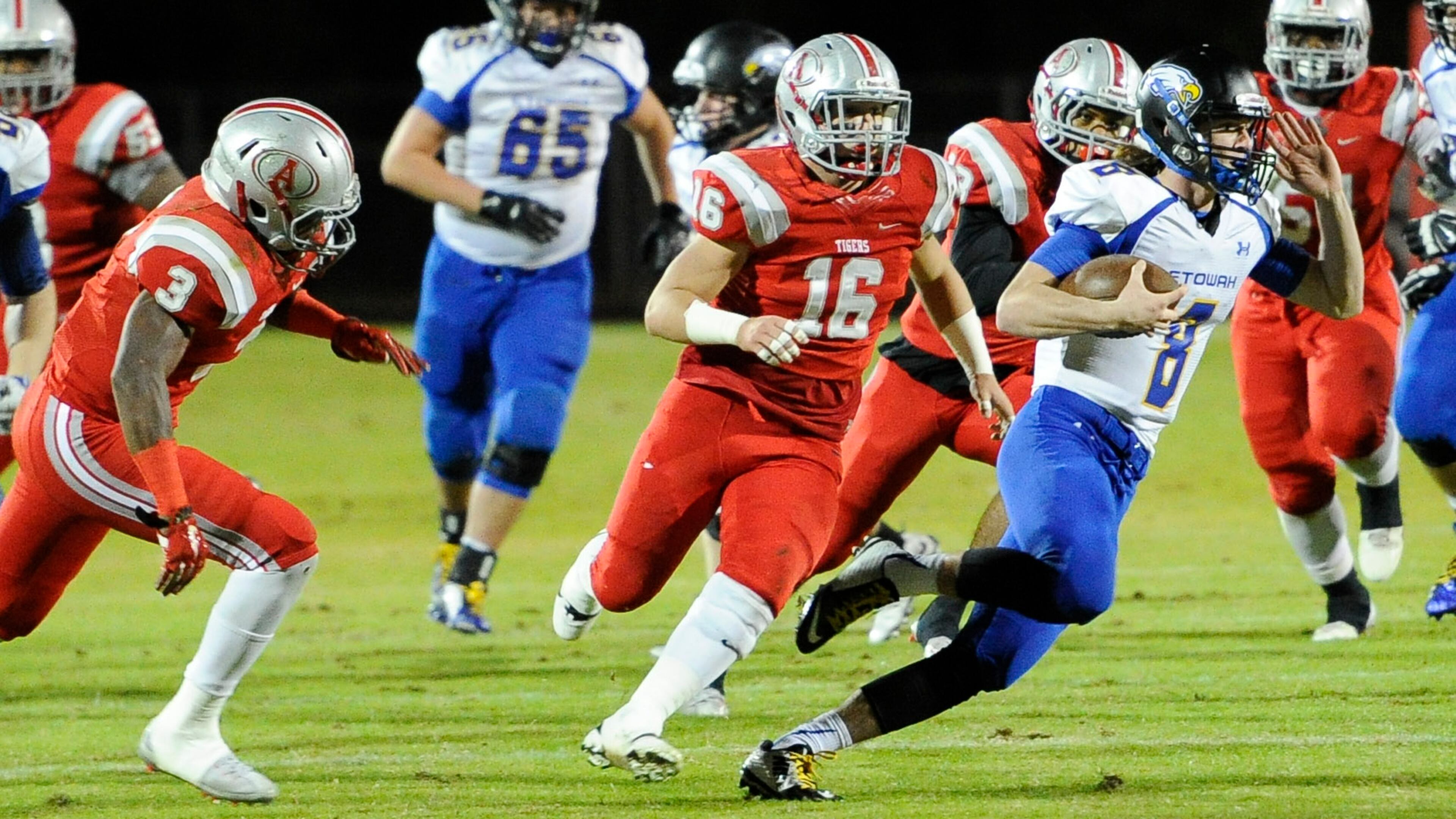Etowah QB Patrick Ferris (8) is chased by Dylan Singleton (3), Frank Finch (16) and other Archer players during a high school football first round playoff game, Friday, Nov. 13, 2015, in Lawrenceville. (Photo/John Amis)