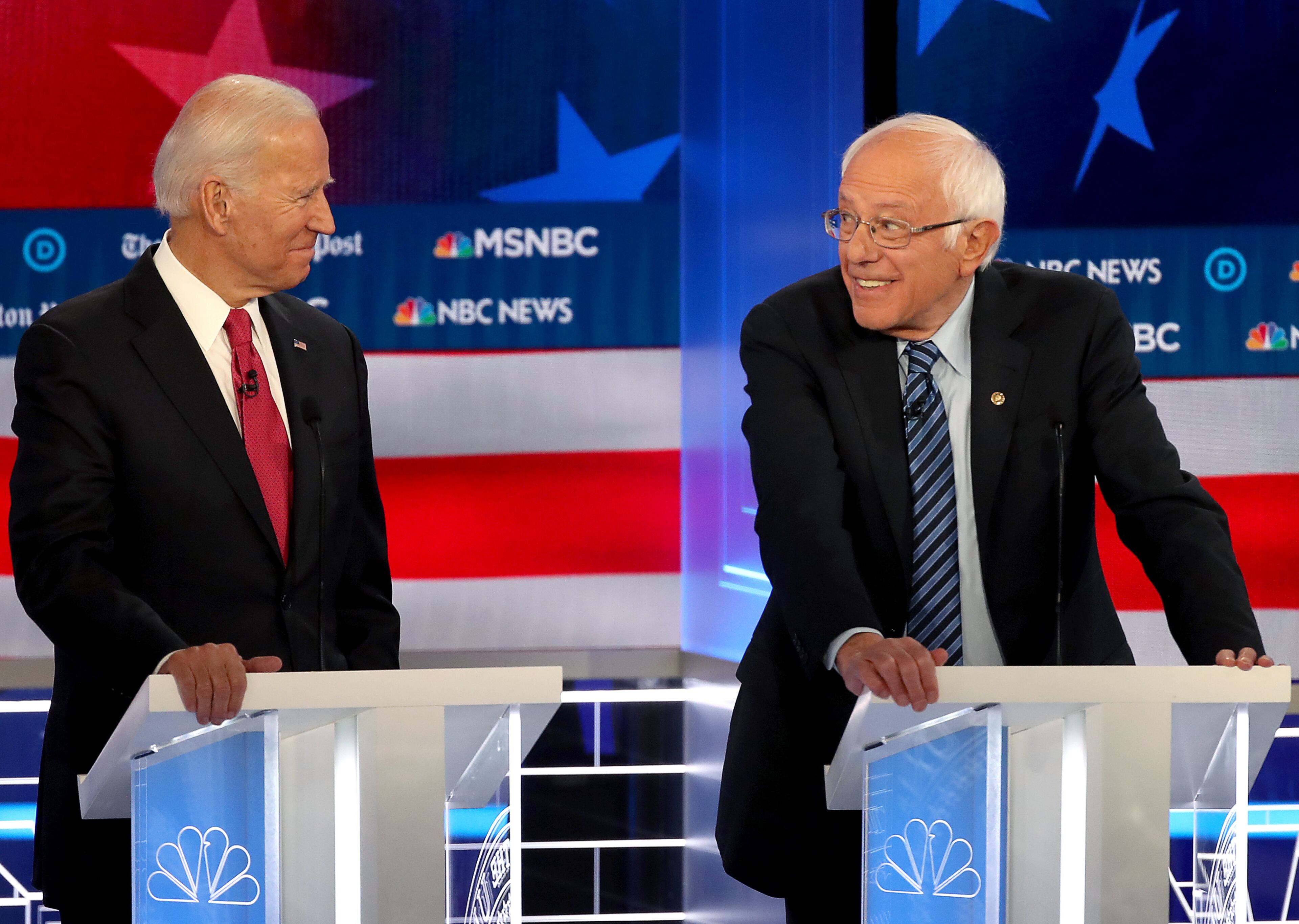 11/20/2019 -- Atlanta, Georgia -- Former Vice President Joe Biden (left) and Senator Bernie Sanders share a smile on stage, during the MSNBC/The Washington Post Democratic Presidential debate inside the Oprah Winfrey Soundstage at Tyler Perry Studios, Monday, November 20, 2019. (Alyssa Pointer/Atlanta Journal Constitution)