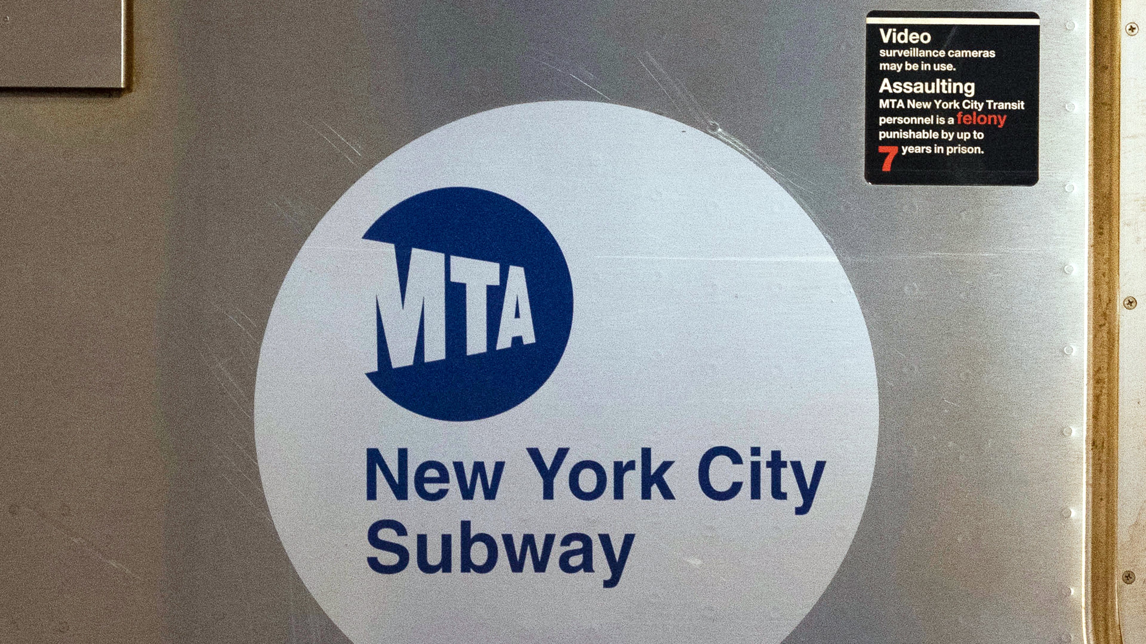 FILE - The MTA logo is seen on the side of a New York City subway car, April 23, 2020, in New York. (AP Photo/Mark Lennihan, File)