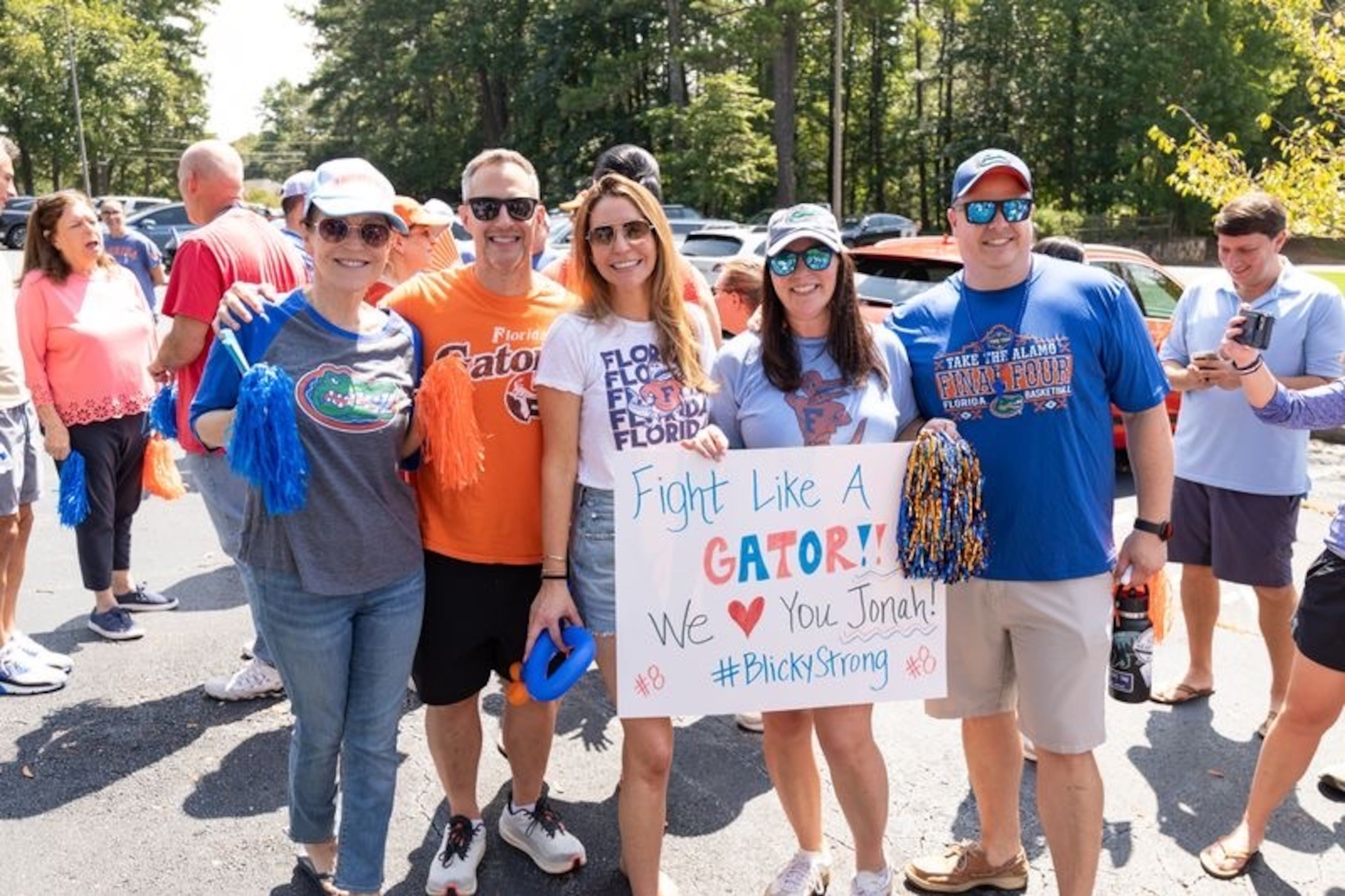 This group of neighbors and supporters holds up a “fight like a gator” sign for Jonah Blick, a 14-year-old who is battling a rare form of brain cancer. (Courtesy of Steven Dewberry)