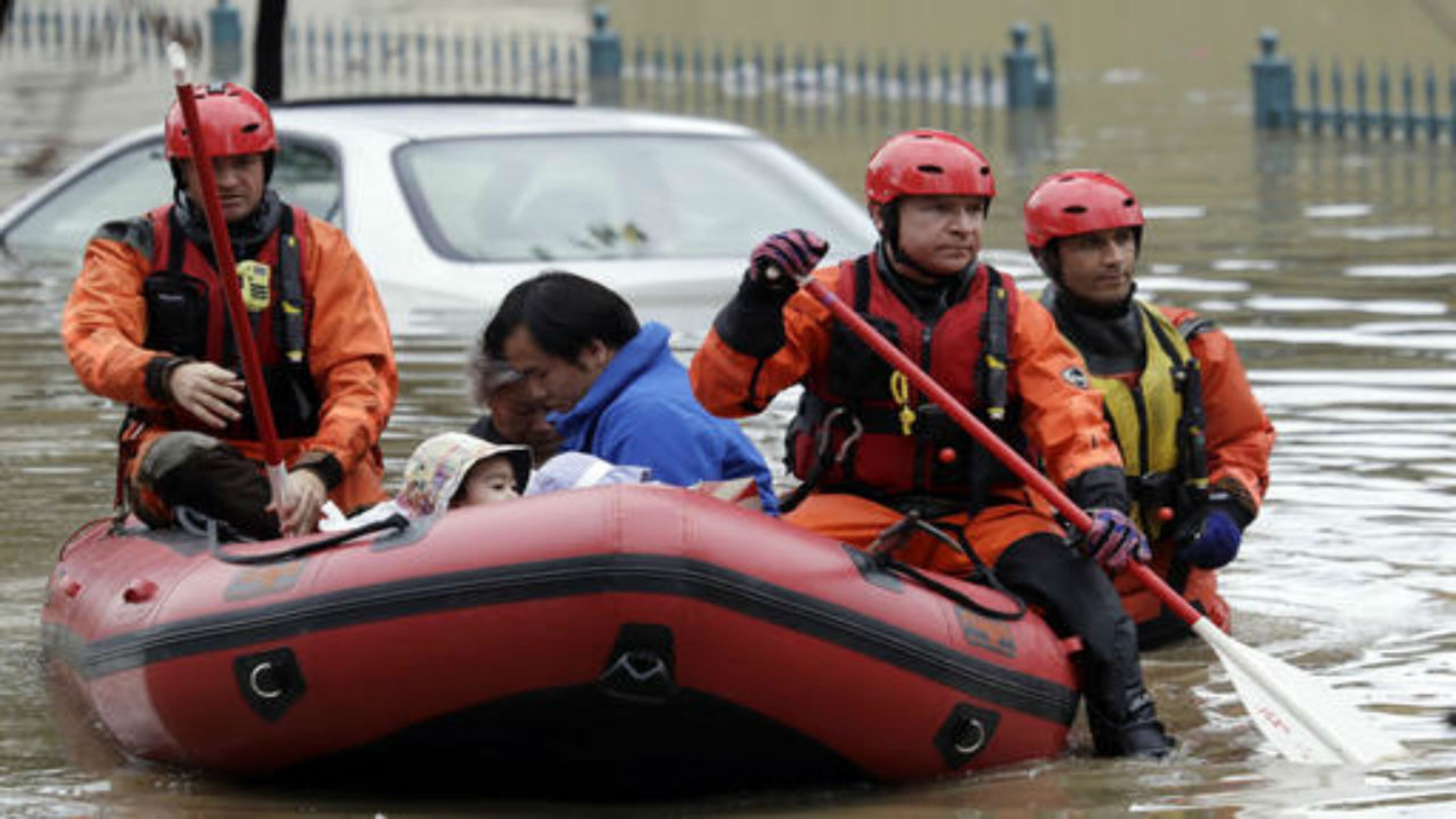 Rescue crews take out residents from a flooded neighborhood Tuesday, Feb. 21, 2017, in San Jose, Calif. Rescuers chest-deep in water steered boats carrying dozens of people, some with babies and pets, from a San Jose neighborhood inundated by water from an overflowing creek Tuesday. (AP Photo/Marcio Jose Sanchez)