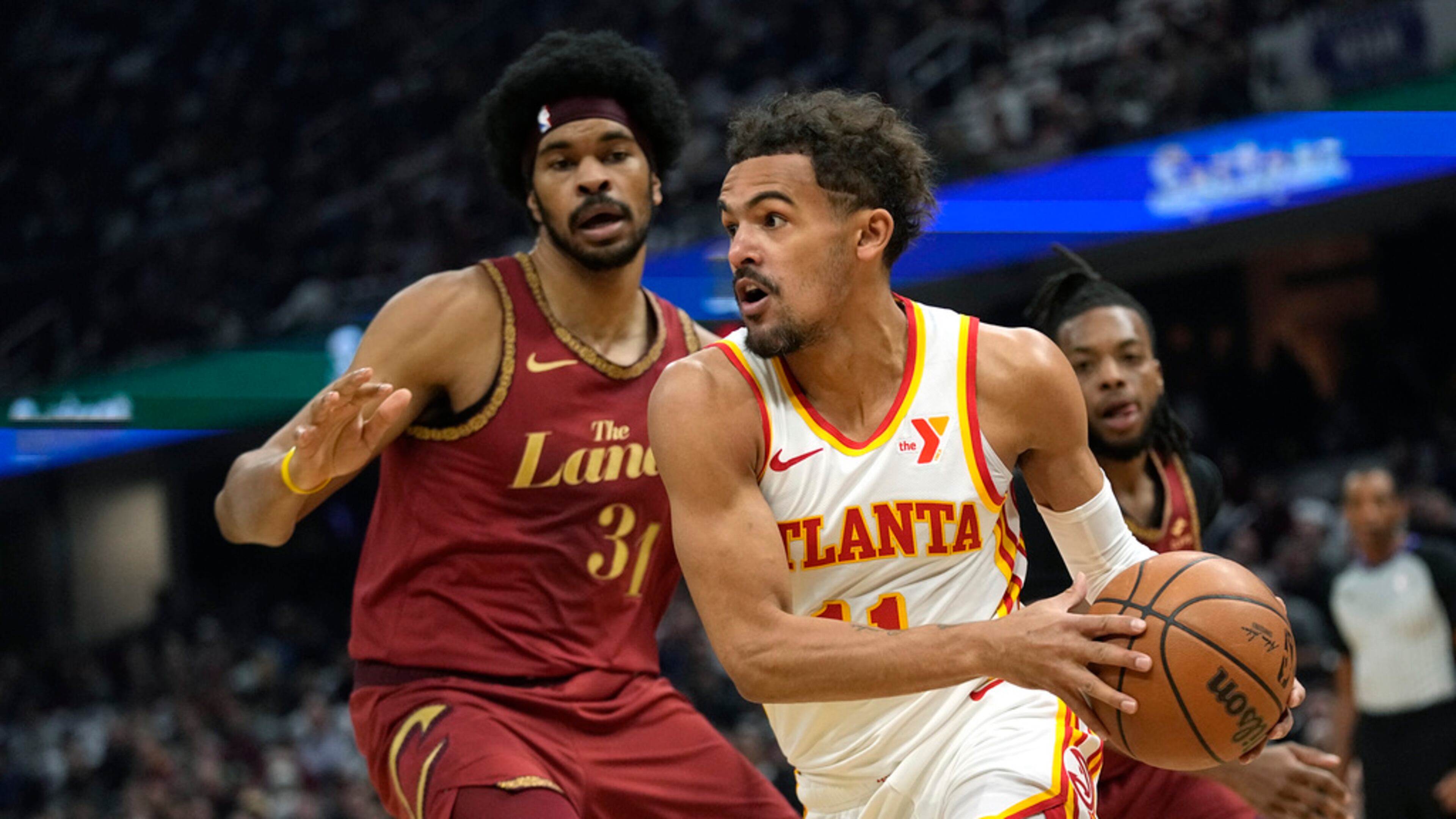 Atlanta Hawks guard Trae Young, right, drives around Cleveland Cavaliers center Jarrett Allen (31) in the first half of an In-Season Tournament NBA basketball game, Tuesday, Nov. 28, 2023, in Cleveland. (AP Photo/Sue Ogrocki)
