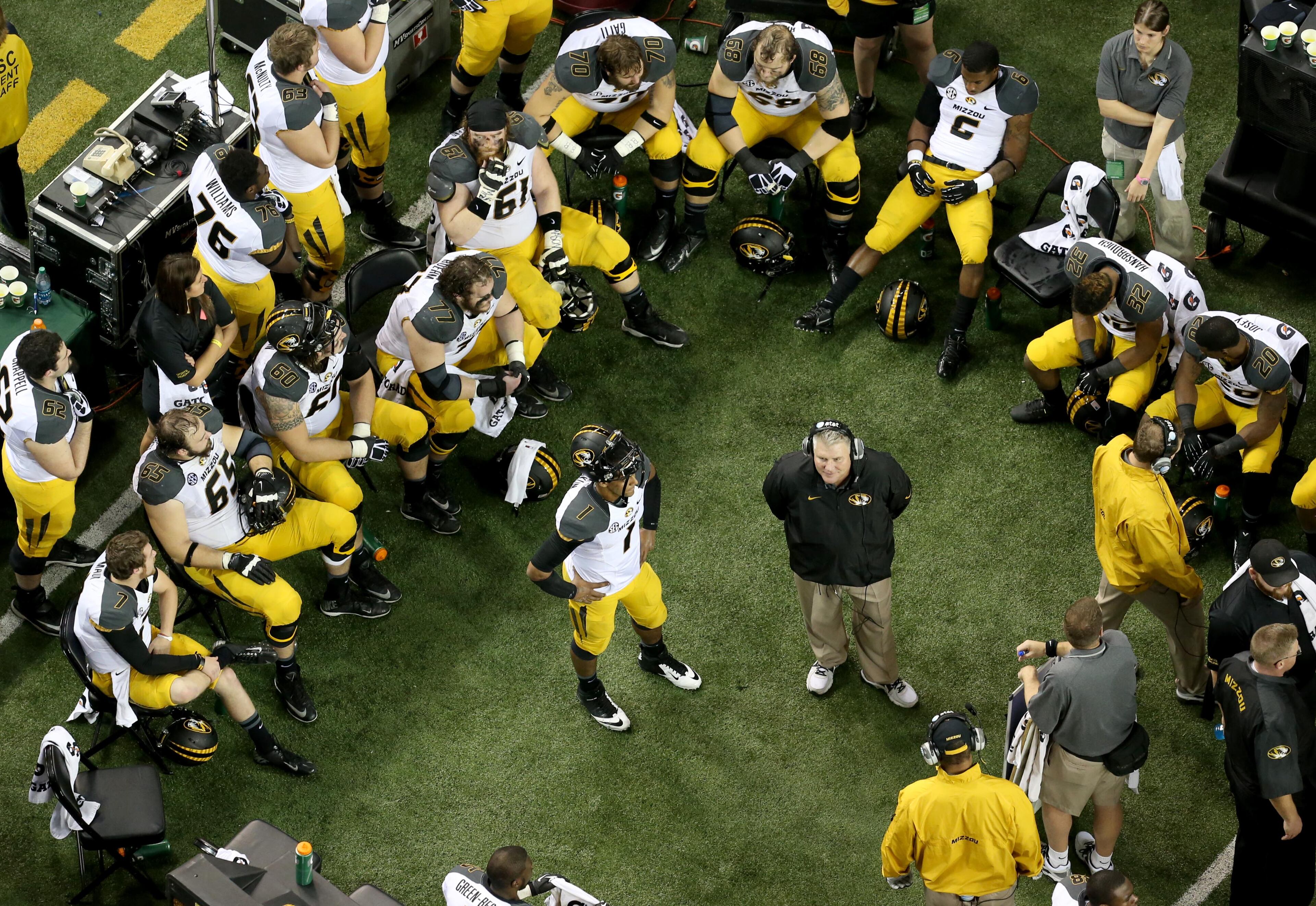 Missouri quarterback James Franklin (1) and other members of the offense can only watch as Auburn drives the ball for another touchdown during Auburn's 59-42 win over Missouri in the SEC Championship Saturday night in Atlanta, Ga., December 7, 2013. JASON GETZ / JGETZ@AJC.COM