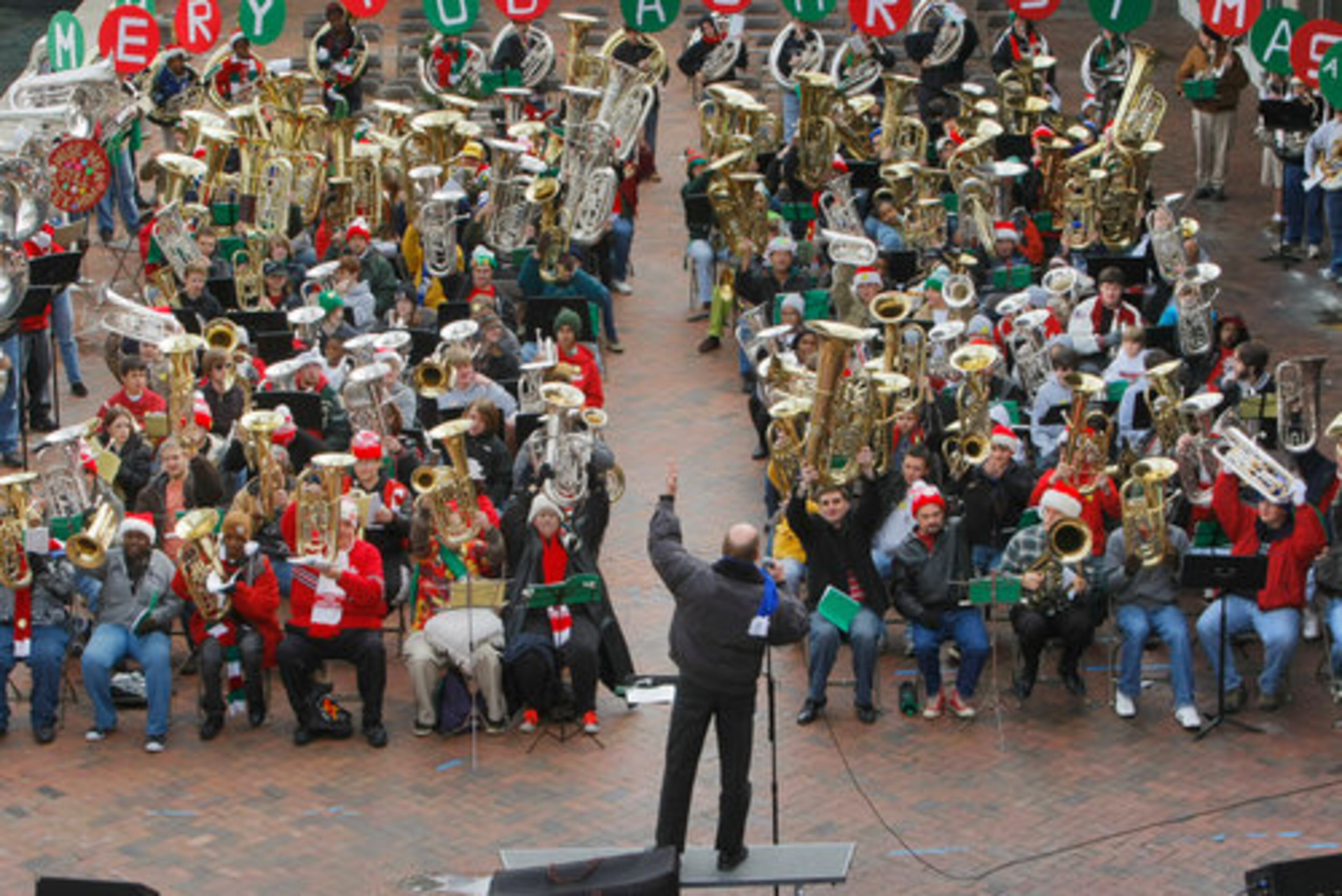 Conductor, Tom Strand (center) prompts musicians to raise their instruments. Some 200 musicians came together Friday, Dec. 4, 2009 for TUBACHRISTMAS at Underground Atlanta.