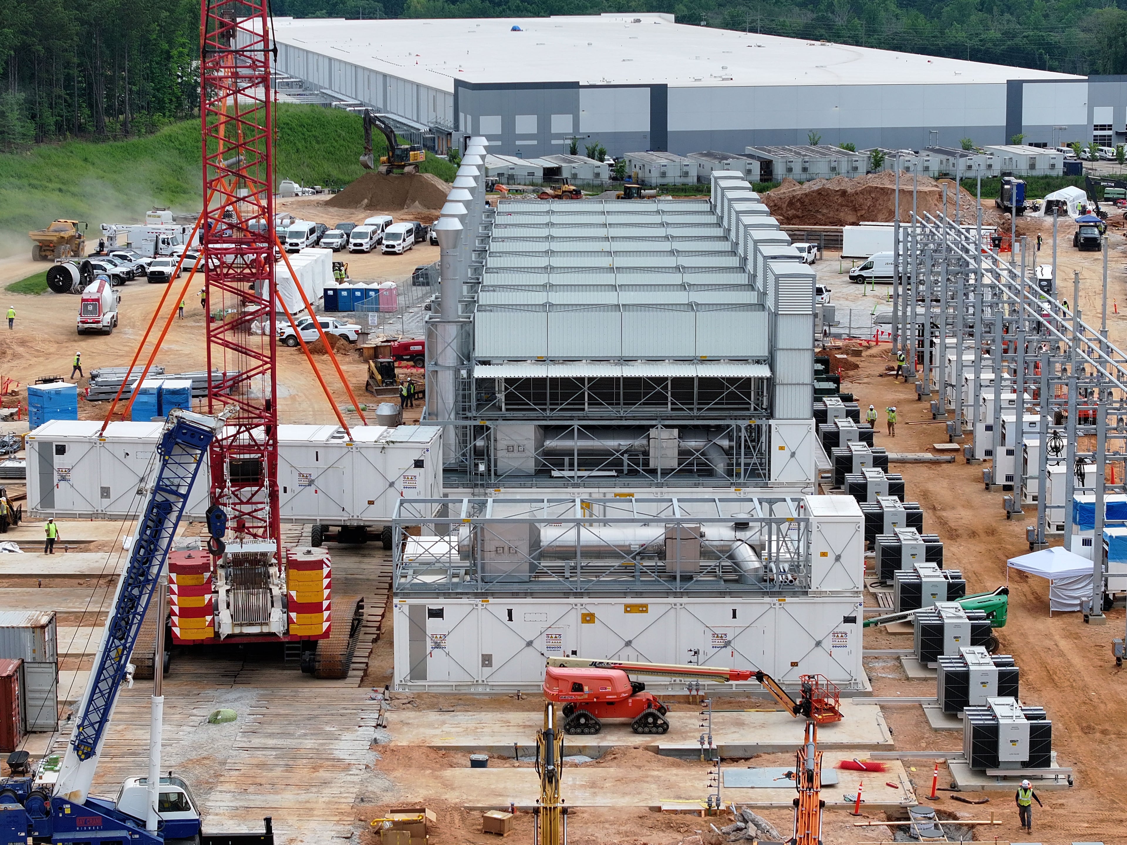 Aerial view of off-grid generators being installed, with the data center in the background, on Thursday, June 25, 2026, in Covington. A data center near Social Circle plans to get its primary power supply from a set of off-grid generators, the first setup of its kind in Georgia. But the company behind the power project was already installing its equipment, despite never obtaining proper permits from the state, a move environmental advocates say raises serious questions about oversight of data centers cropping up across Georgia. (Hyosub Shin/AJC)