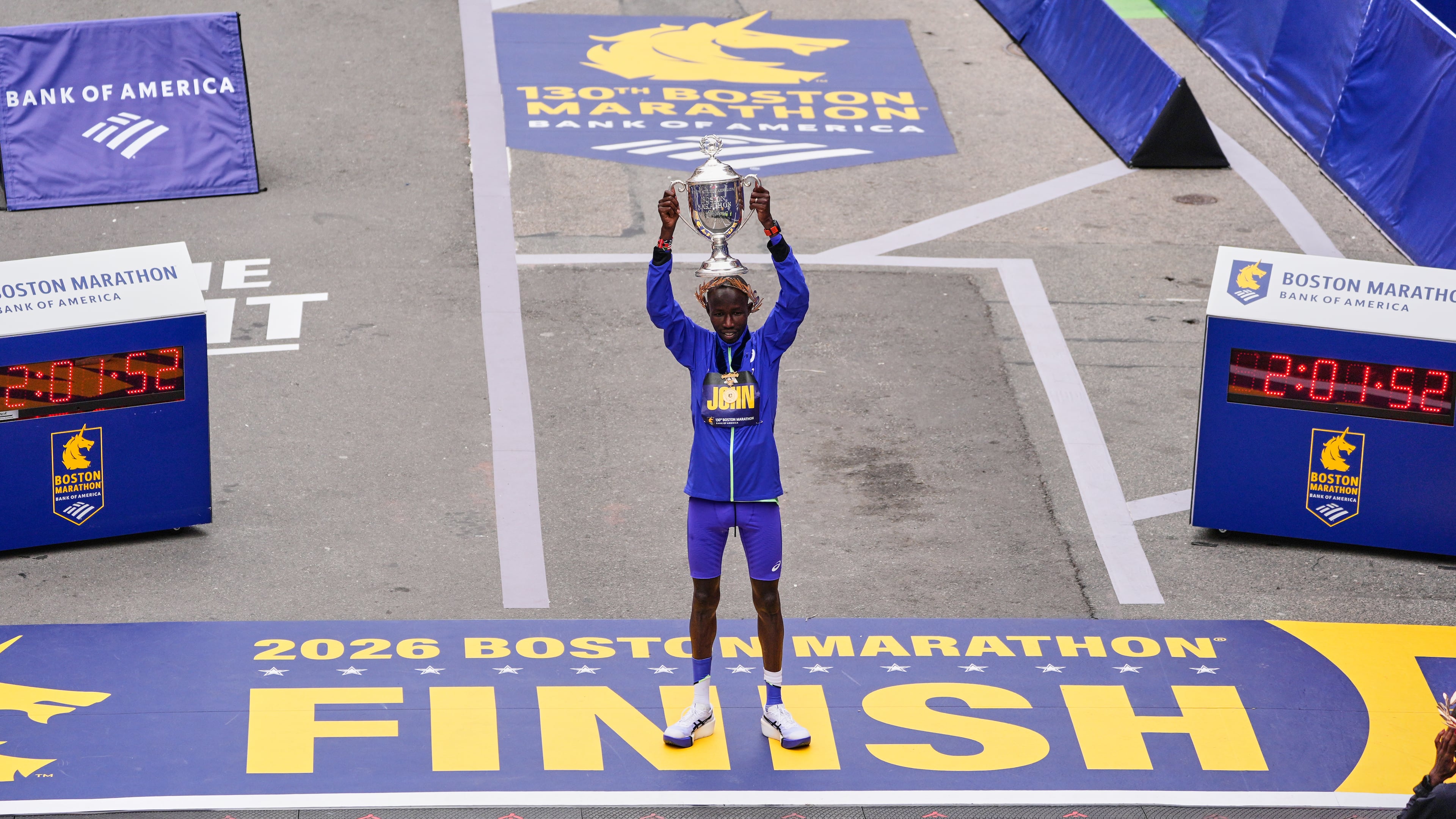 John Korir of Kenya, hoist the trophy after winning the Boston Marathon, Monday, April 20, 2026, in Boston. (AP Photo/Charles Krupa)
