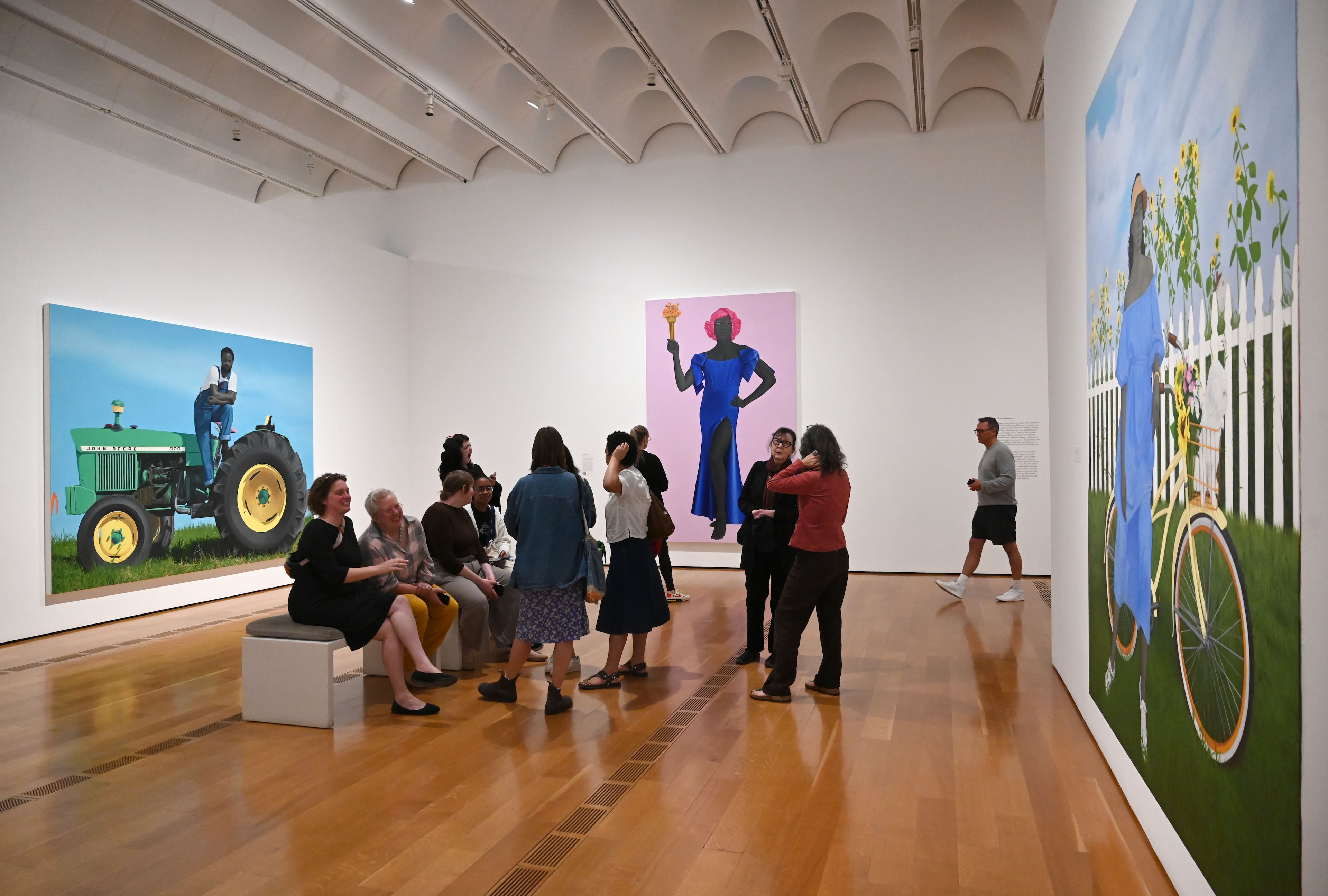 Visitors enjoy Georgia-born artist Amy Sherald’s paintings in the “American Sublime” exhibition at the High Museum of Art on Friday, May 15, 2026, in Atlanta. (Hyosub Shin/AJC)