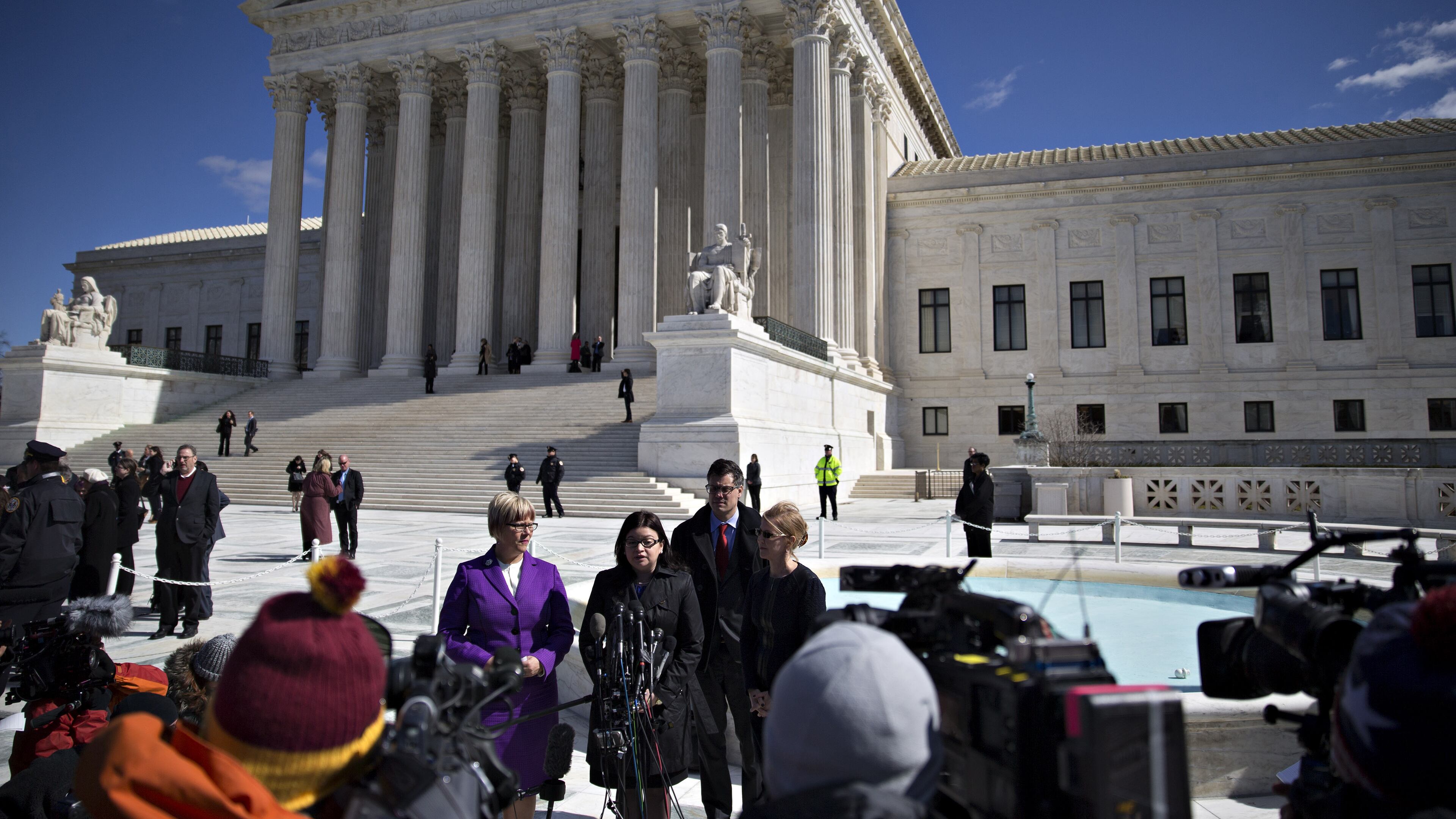 Stephanie Toti, senior counsel at the Center for Reproductive Rights, center, speaks to members of the media outside the U.S. Supreme Court with Amy Hagstrom Miller, founder and chief executive officer of Whole Woman's Health, left, and Nancy Northup, president and chief executive officer of the Center for Reproductive Rights, right, in Washington, on March 2, 2016. In a presidential campaign unlike any other, the U.S. Supreme Court has been treated almost as an afterthought, but that will change on Wednesday night.Debate moderator Chris Wallace of Fox News is making the high court one of six topics for the final debate between Donald Trump and Hillary Clinton, and the timing couldn't be better.