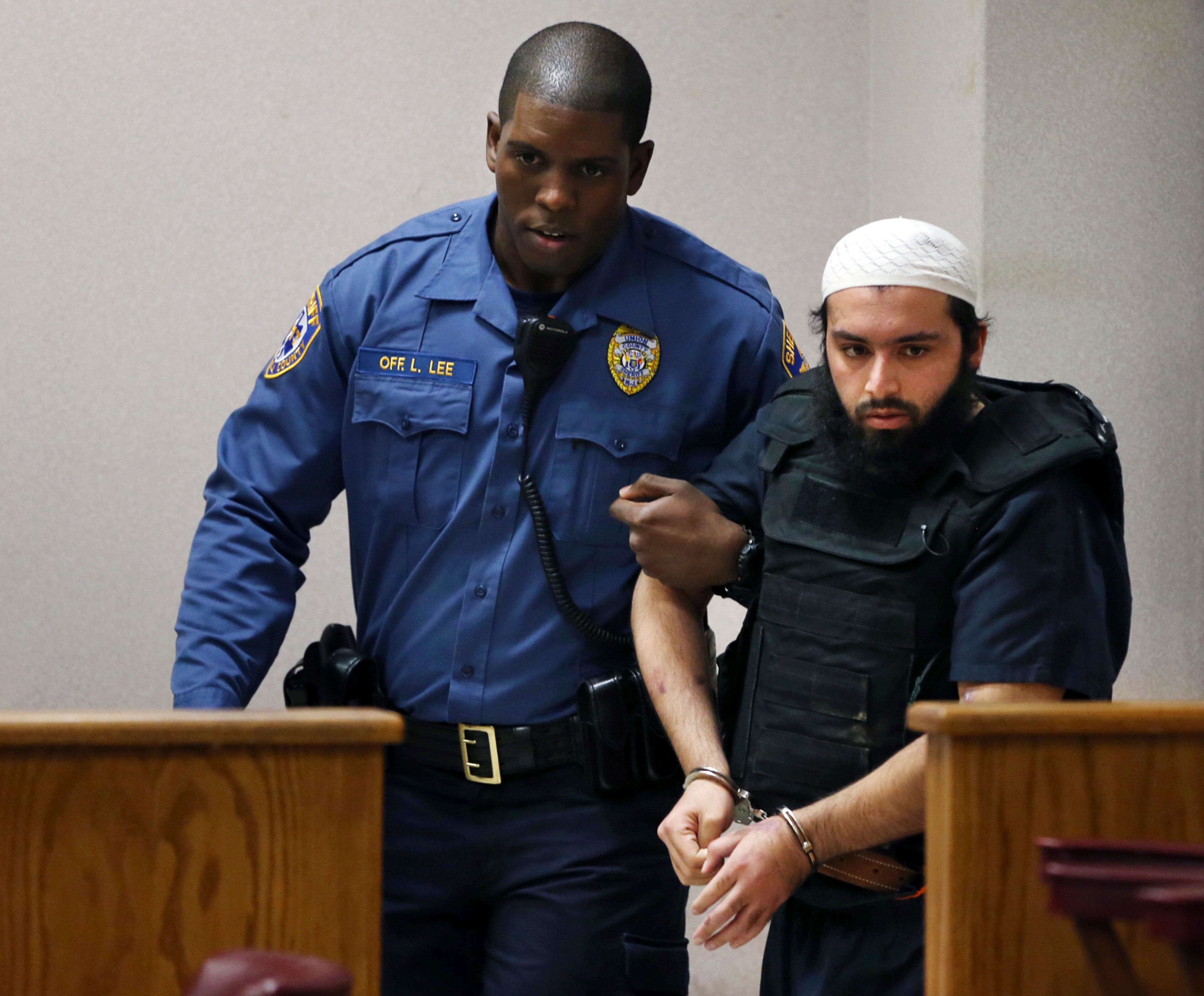Ahmad Khan Rahimi, the man accused of setting off bombs in New Jersey and New York in September, injuring more than 30 people, is led into court Tuesday, Dec. 20, 2016, in Elizabeth, N.J. (AP Photo/Mel Evans)