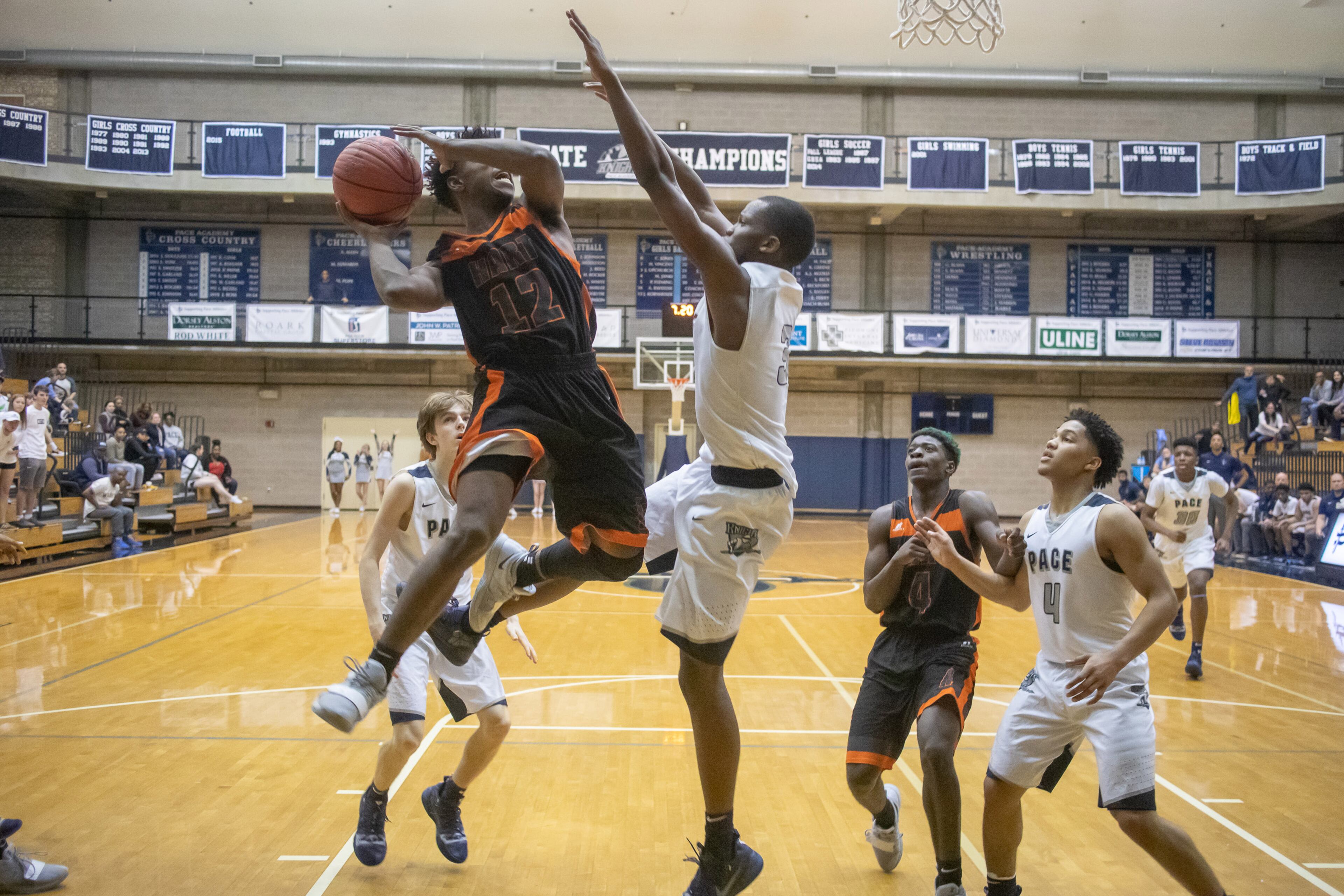 Hart County High School basketball player Elijah Robison tries to take a shot while being guarded by Pace Academy High School player Madison, Durr during the first round of the state basketball tournament at Pace Academy high school Saturday, February 16, 2019. STEVE SCHAEFER / SPECIAL TO THE AJC