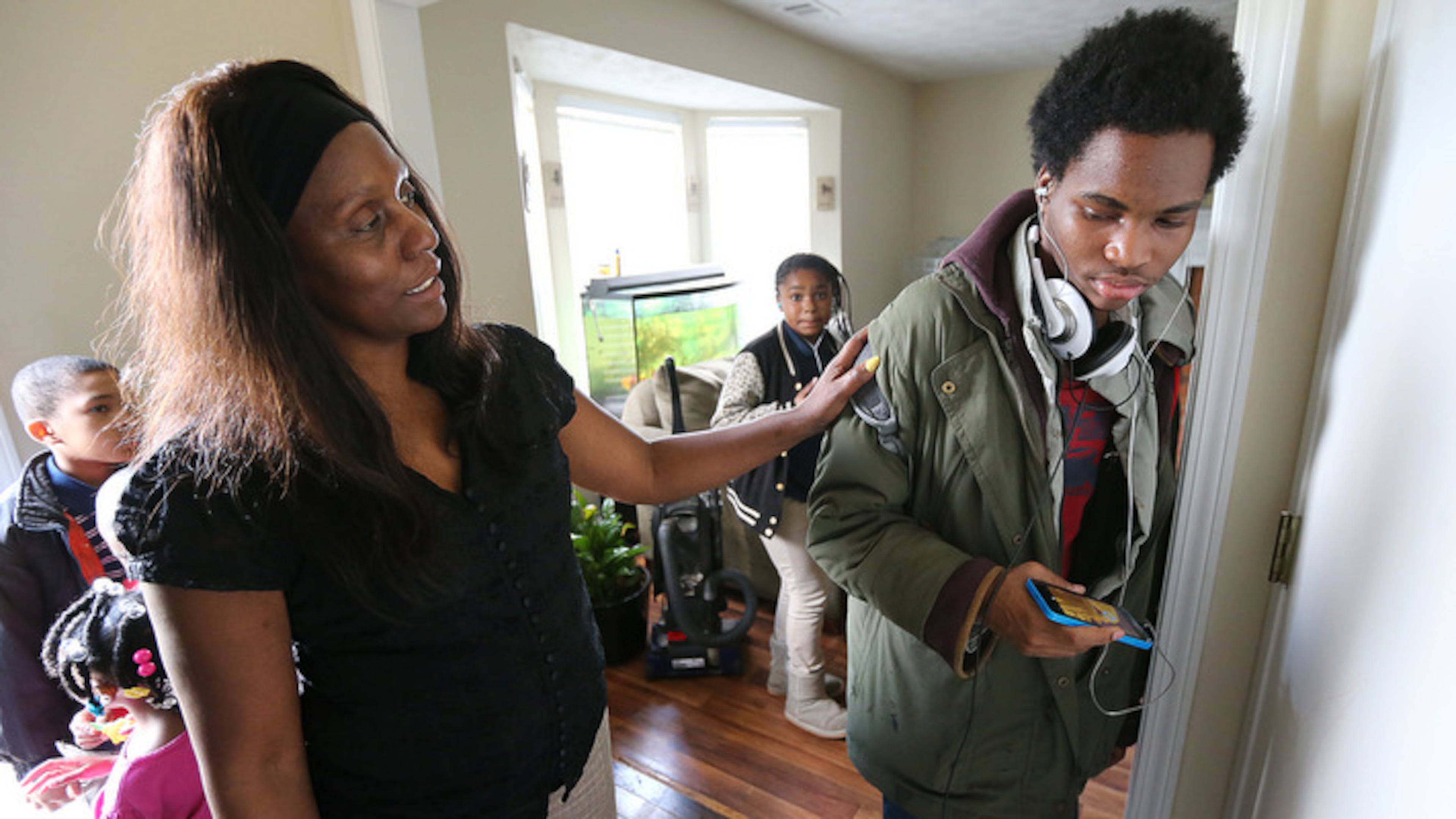 031416 Atlanta: Loretta Jenkins checks on her special needs grandson Markey, 18, when he arrives home from school on Monday, March 14, 2016, in Atlanta. Jenkins, 52, is raising five grandchildren after the death of her daughter from cancer three years ago and the mental illness of another. Curtis Compton / ccompton@ajc.com