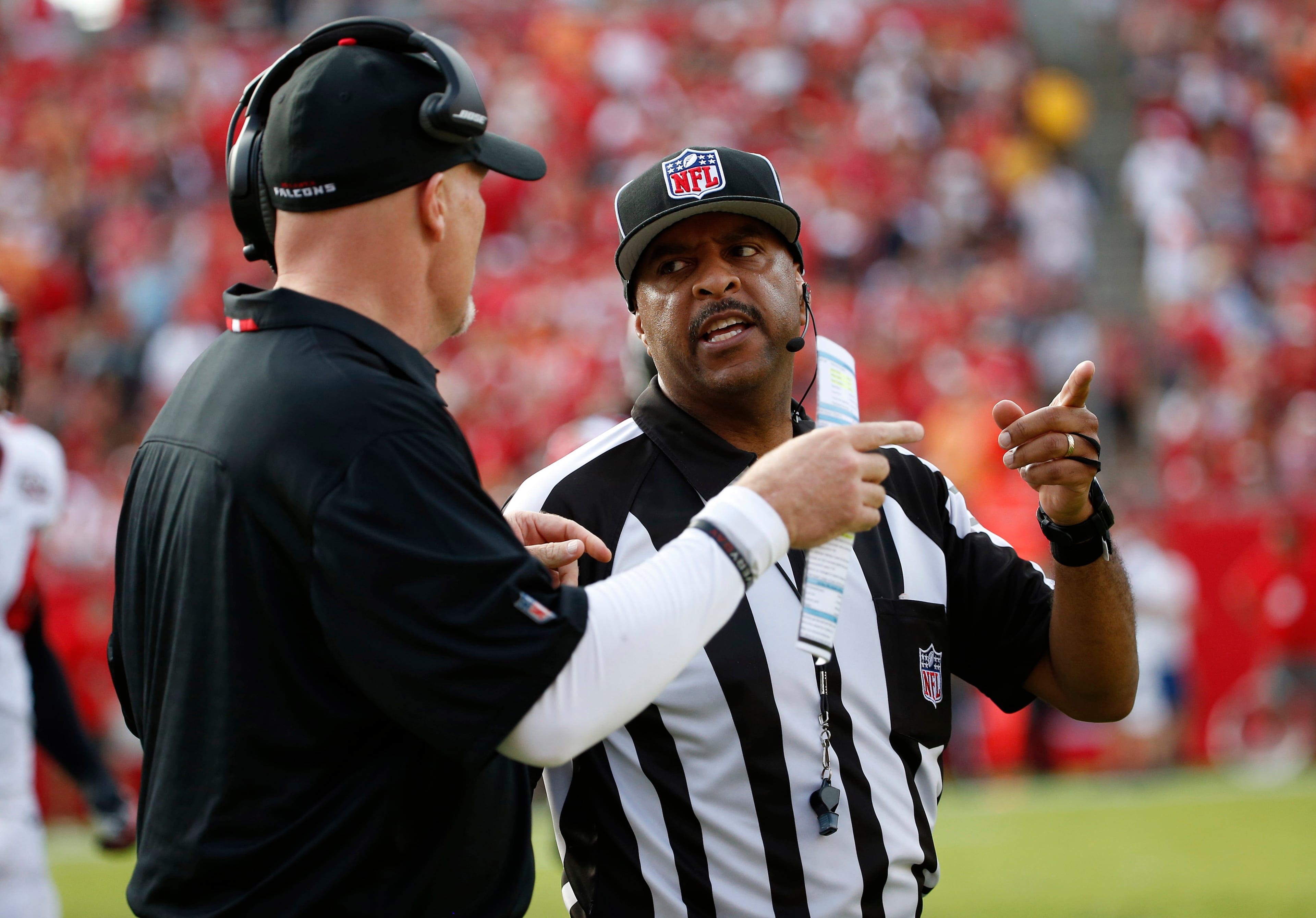 NFL field judge Adrian Hill (29) talks to Atlanta Falcons head coach Dan Quinn during the third quarter of an NFL football game Sunday, Dec. 6, 2015, in Tampa, Fla. (AP Photo/Brian Blanco)