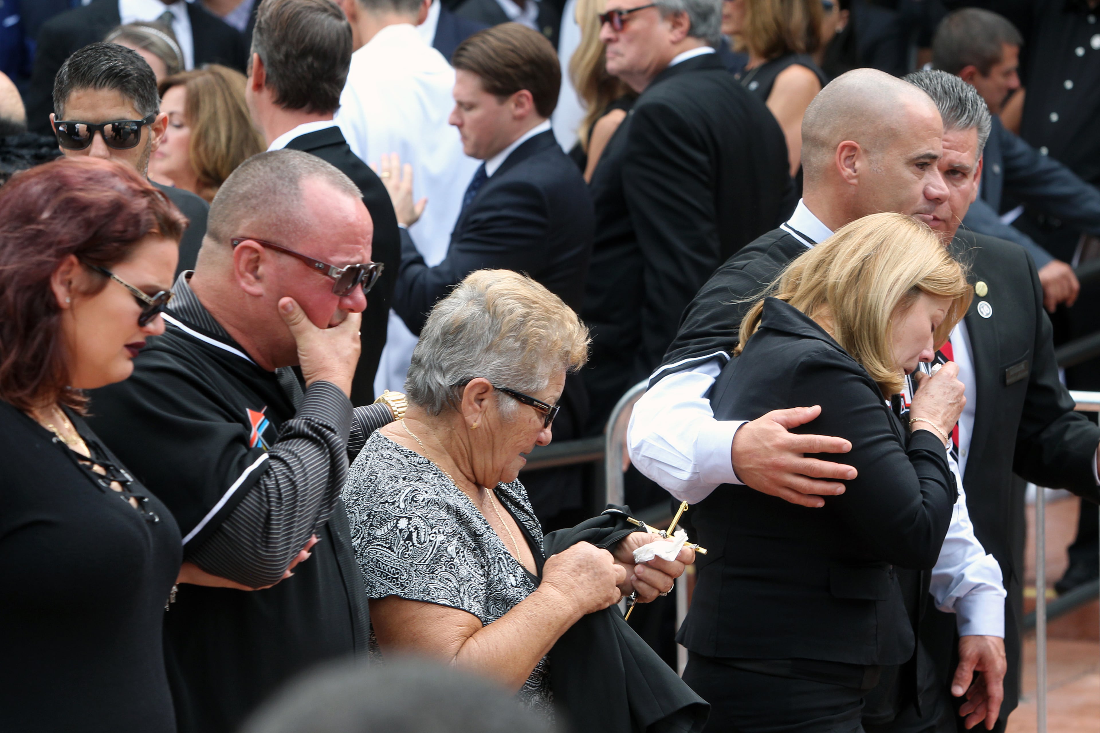 Maritza Fernandez, the mother of Miami Marlins pitcher Jose Fernandez, right, Olga Fernandez, his grandmother, center, and Ramon Jimenez, who helped raise him, after a memorial service at St. Brendan Catholic Church in Miami on Thursday, Sept. 29, 2016. (Roberto Koltun/El Nuevo Herald/TNS)