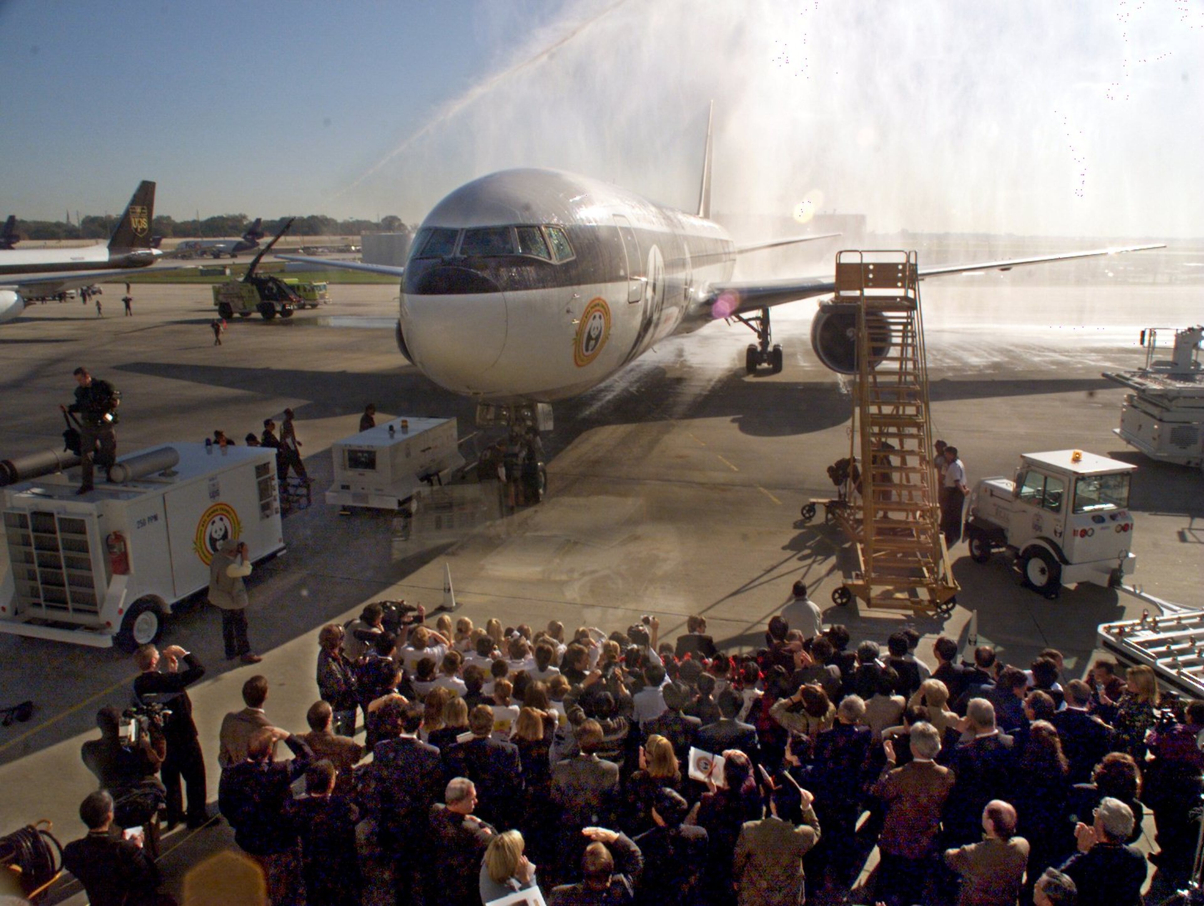HARTSFIELD INTERNATIONAL AIRPORT- Two giant Pandas, Lun Lun and Yang Yang were safely delivered 11/05/99 from Beijing to the UPS facility in the cargo section of Hartsfield. UPS workers offloaded the Boeing 767 containers containing the bears on the tarmac following a welcome spray of water by fire apparatus as the plane taxied in on it's arrival. The bears were escorted by police motorcade to the their new 7 million dollar Panda habitat where they will be quarantined until November 20th for their 1st public exhibit. (JOHN SPINK / AJC STAFF)