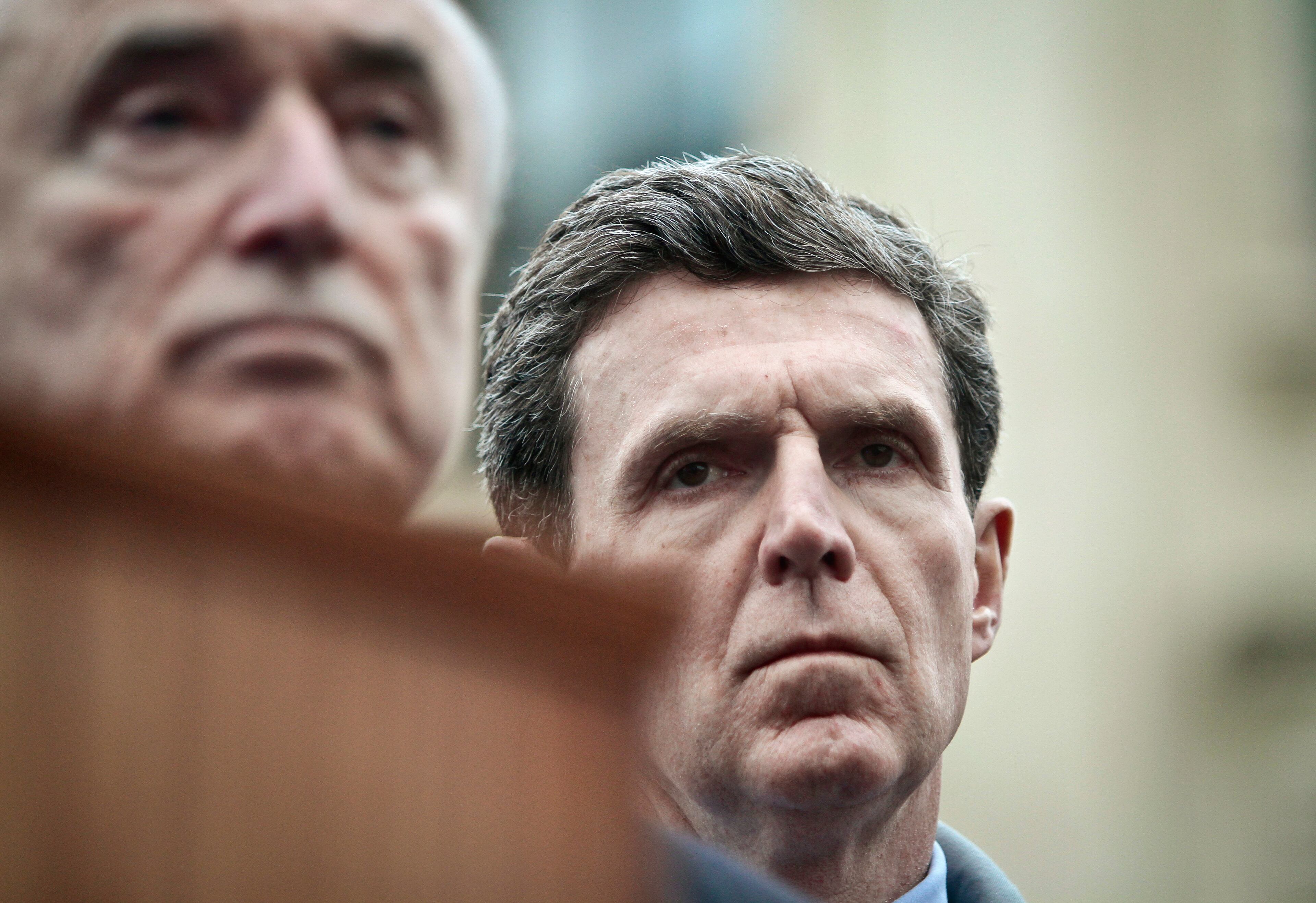 New York city police commissioner Bill Bratton, left, and Con Edison chief executive John McAvoy, right, listen during a news conference after visiting the site of an explosion that leveled two apartment buildings in Harlem, Wednesday March 12, 2014 in New York. Con Edison spokesman Bob McGee says a resident from a building adjacent to the two that collapsed reported that he smelled gas inside his apartment, but thought the odor could be coming from outside. (AP Photo/Bebeto Matthews)