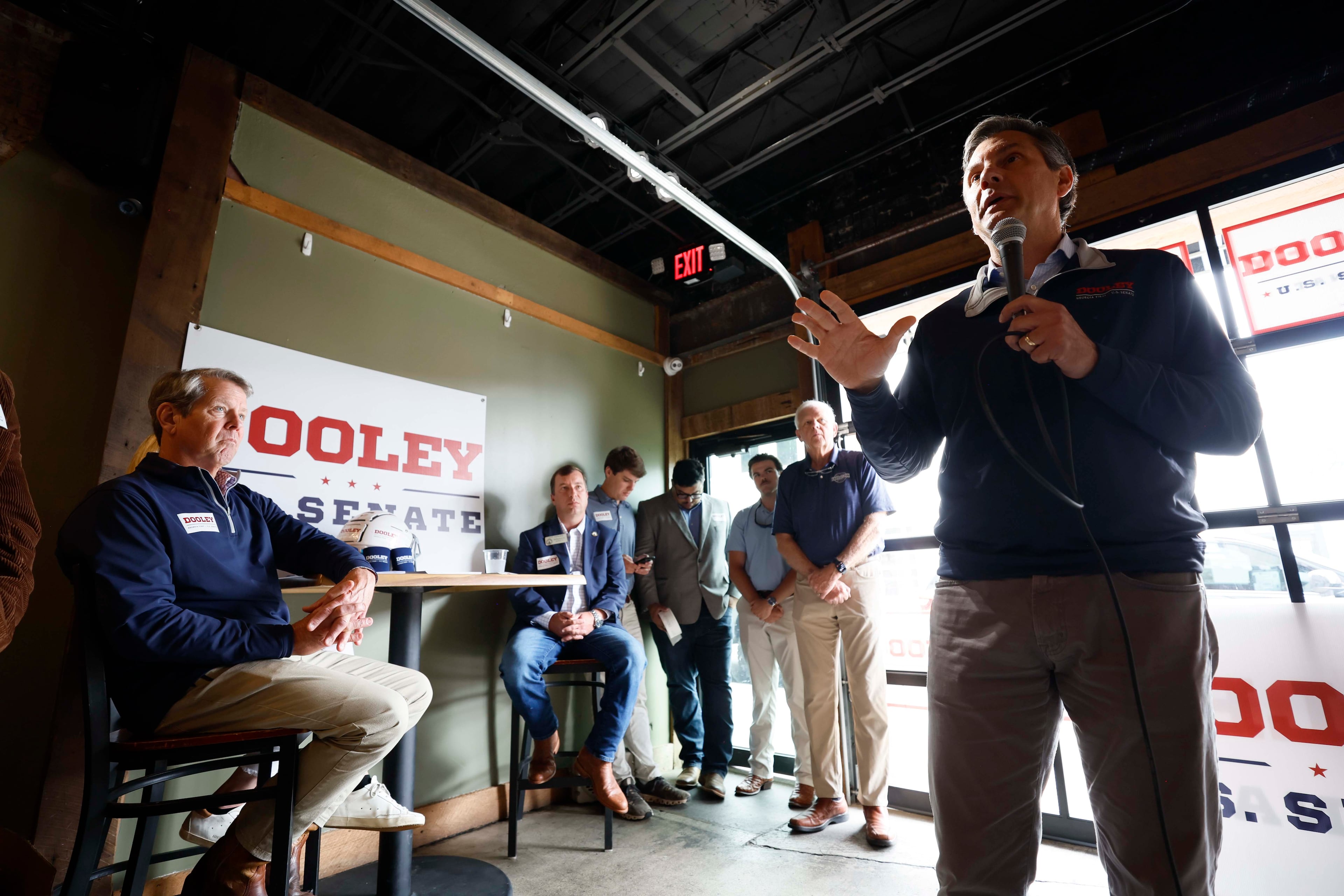 U.S. Senate candidate Derek Dooley speaks to supporters during a campaign event in downtown Carrollton earlier this month as Gov. Brian Kemp looks on. (Miguel Martinez/AJC)