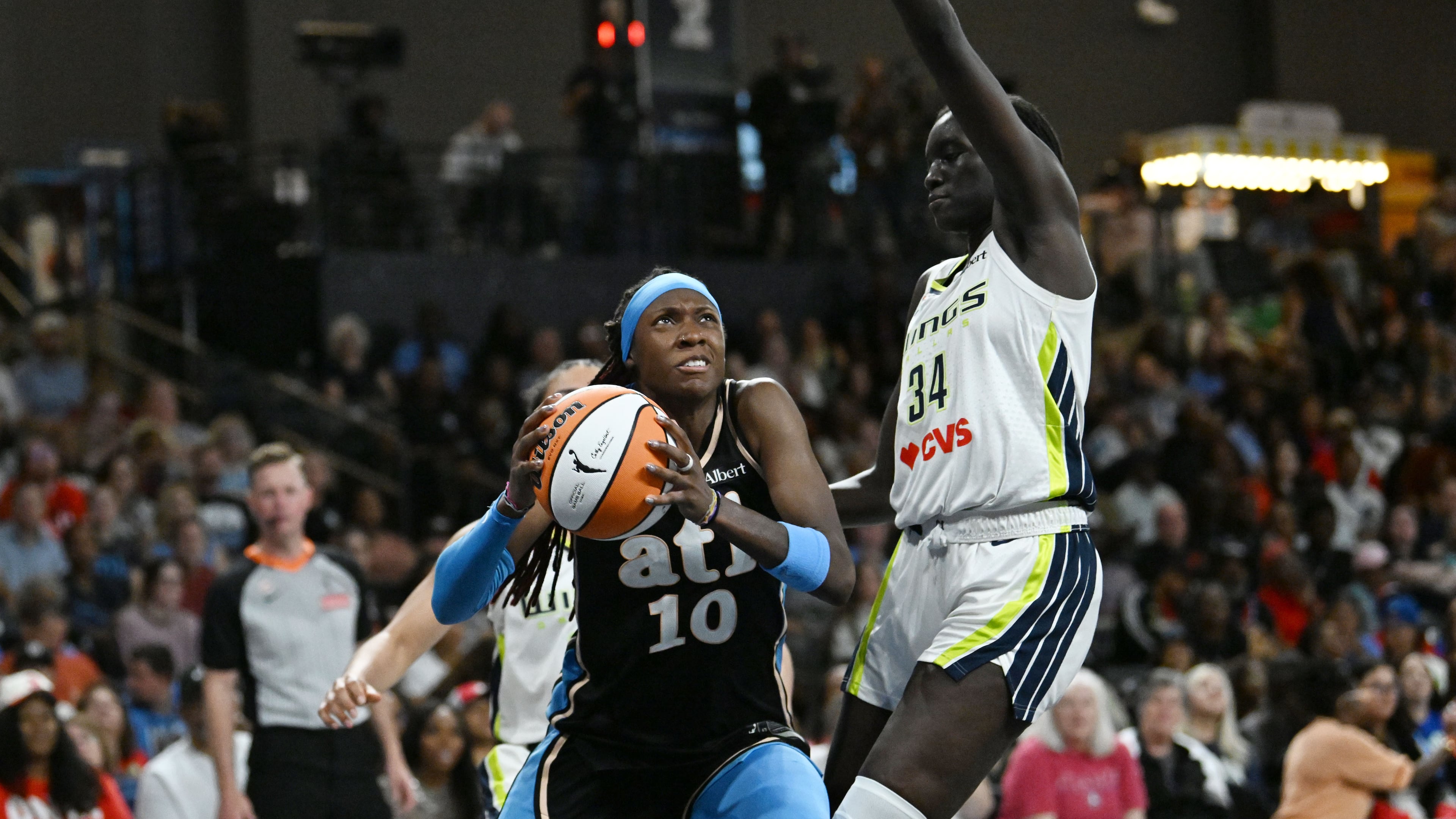 Atlanta Dream guard Rhyne Howard (10) drives against Dallas Wings forward Awak Kuier (34) during the second half of a WNBA game at Gateway Center Arena on Friday, May 22, 2026, in Atlanta. Atlanta Dream won 86-69 over Dallas Wings. (Hyosub Shin/AJC)