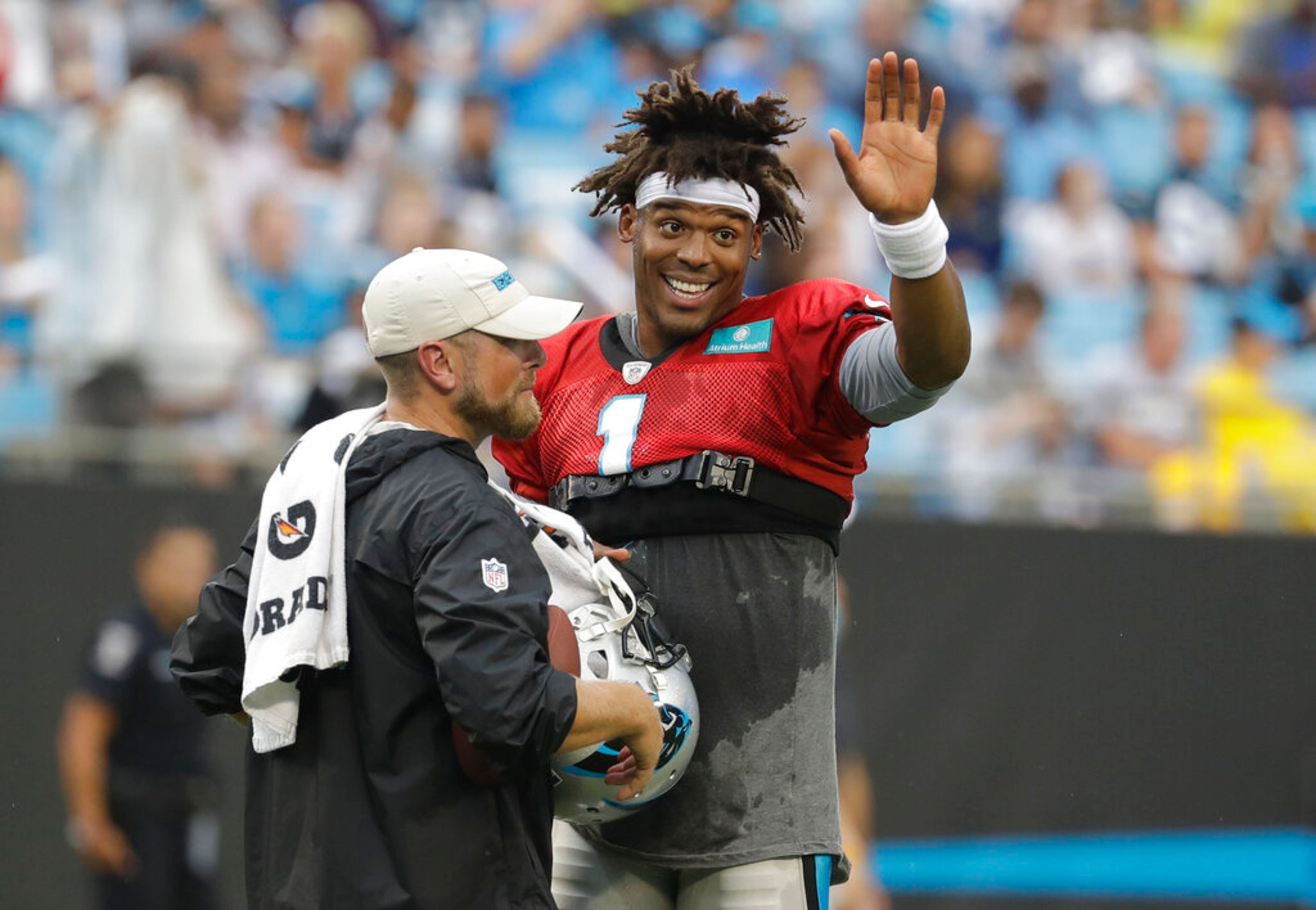 Carolina Panthers' Cam Newton waves to fans during a Fan Fest practice at the NFL football team's training camp in Charlotte, N.C., Friday, Aug. 2, 2019. (AP Photo/Chuck Burton)