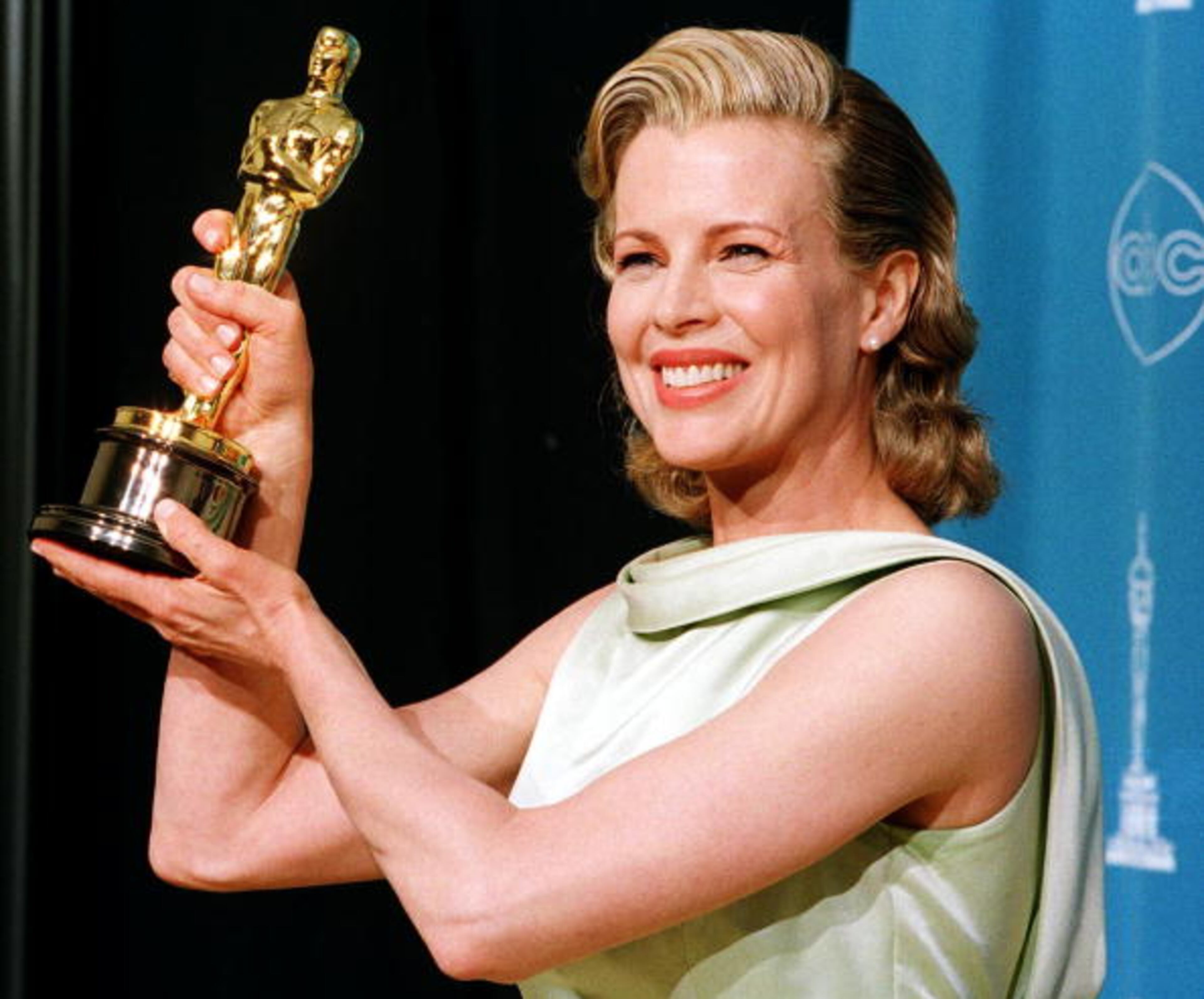 LOS ANGELES, CA - MARCH 23: Actress Kim Basinger holds up her Oscar for Best Supporting Actress for her role in "L.A. Confidential" during the 70th Annual Academy Awards 23 March in Los Angeles. (Photo credit should read HAL GARB/AFP/Getty Images)