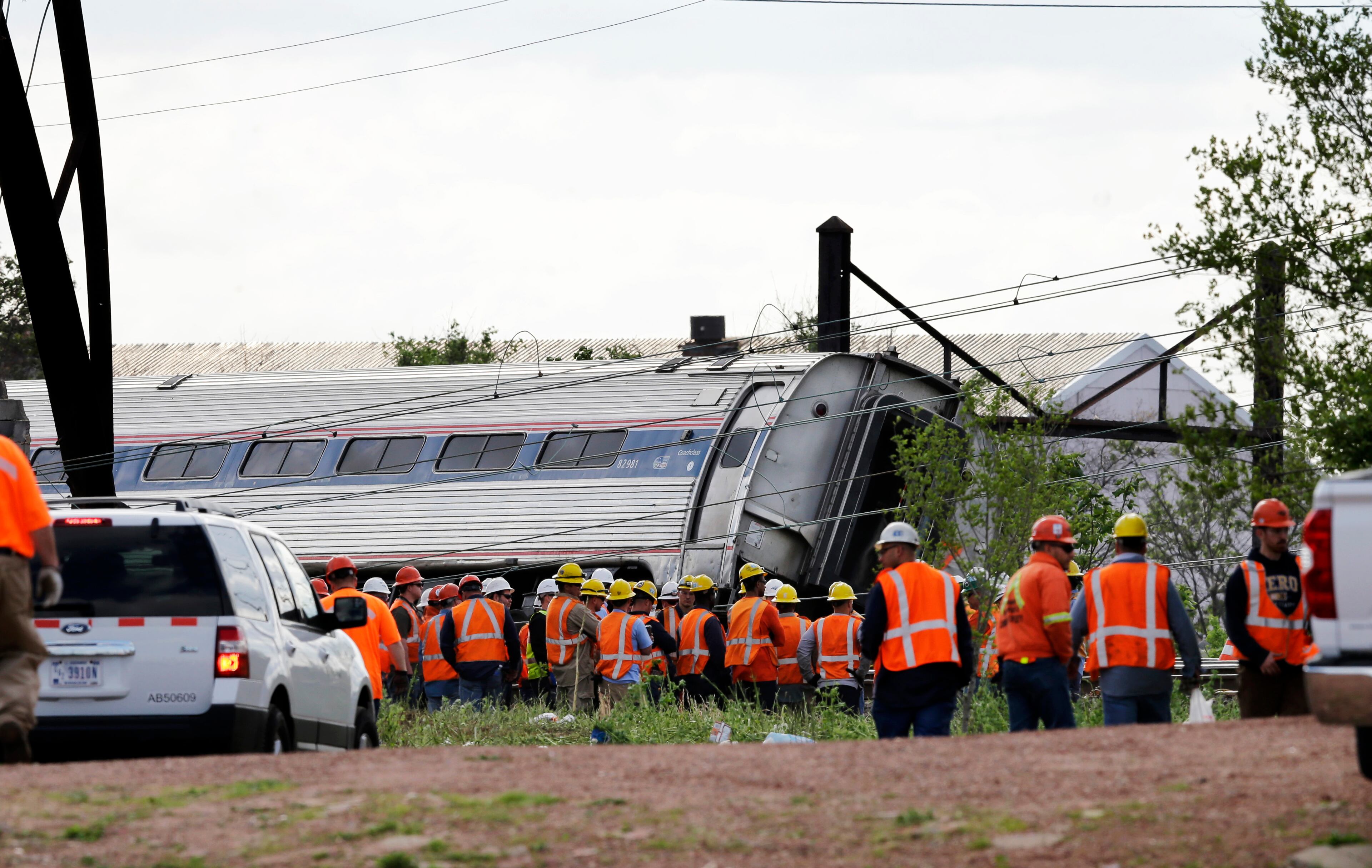 Emergency personnel gather near the scene of a deadly train derailment, Wednesday, May 13, 2015, in Philadelphia. An Amtrak train headed to New York City derailed and crashed in Philadelphia on Tuesday night. (AP Photo/Mel Evans)