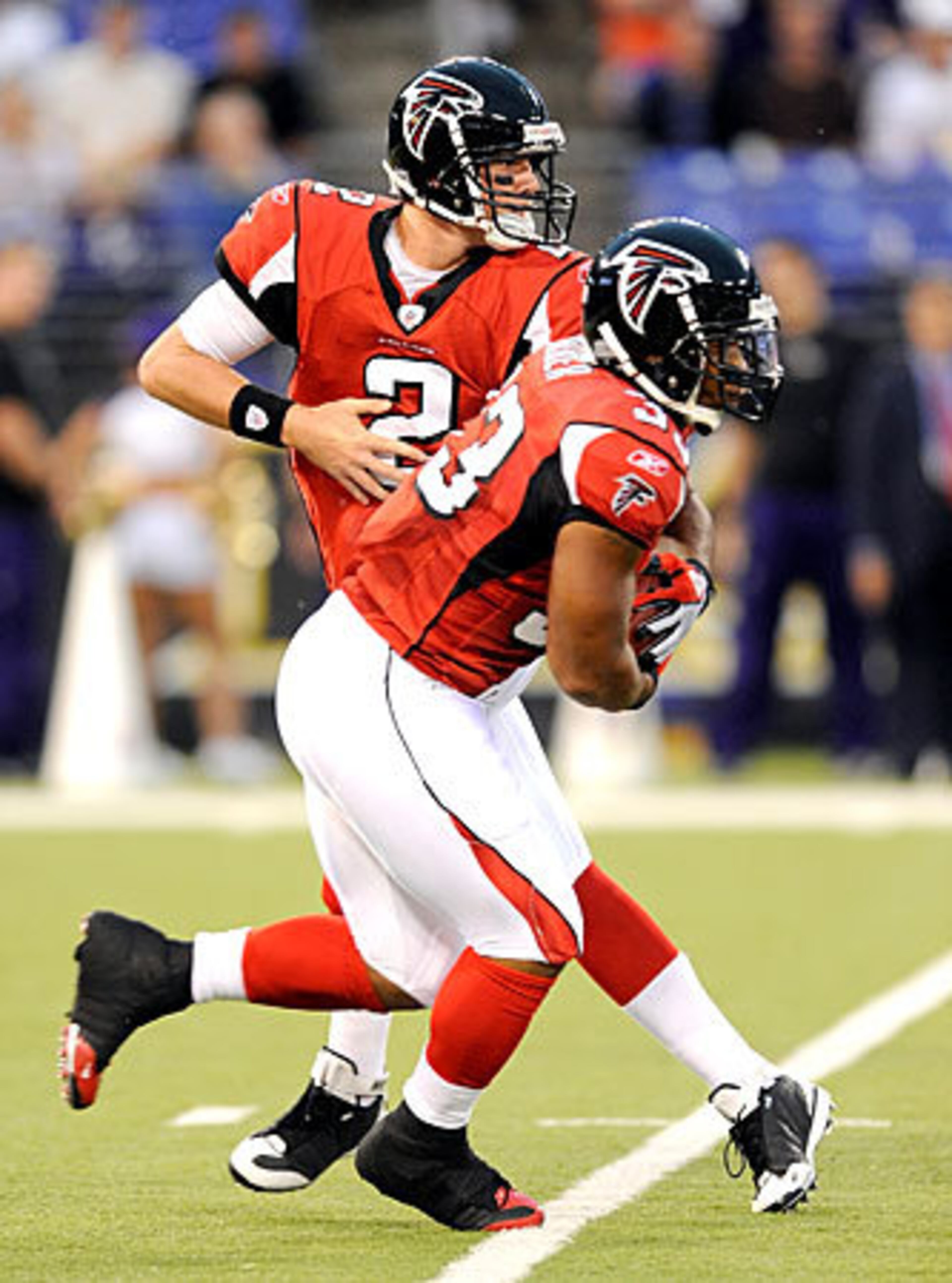 Ryan hands the ball off to Turner during the first half against the Ravens.