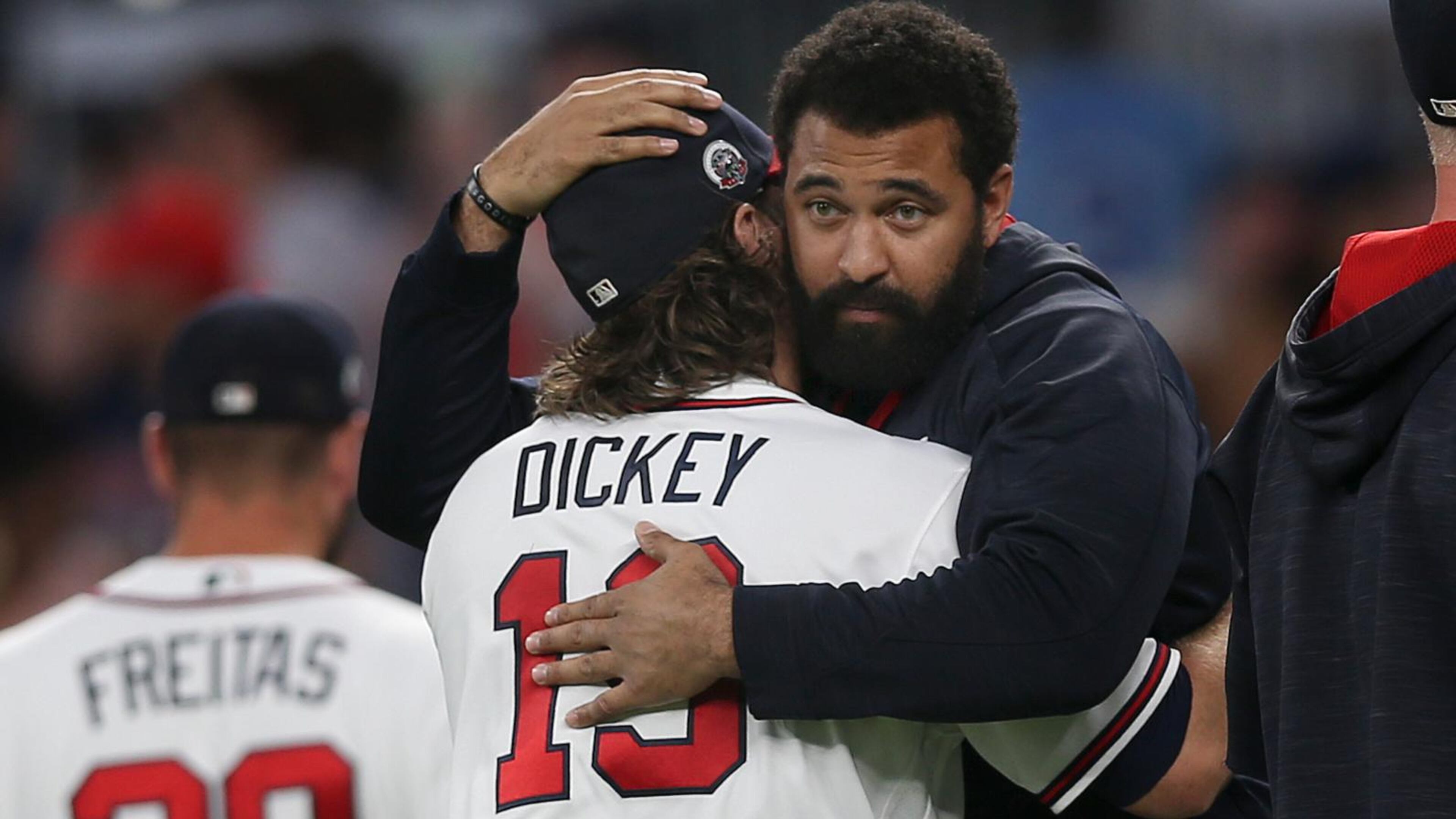 Braves starting pitcher R.A. Dickey gets a hug from teammate Matt Kemp after a win over the Washington Nationals. (AP Photo/John Bazemore)