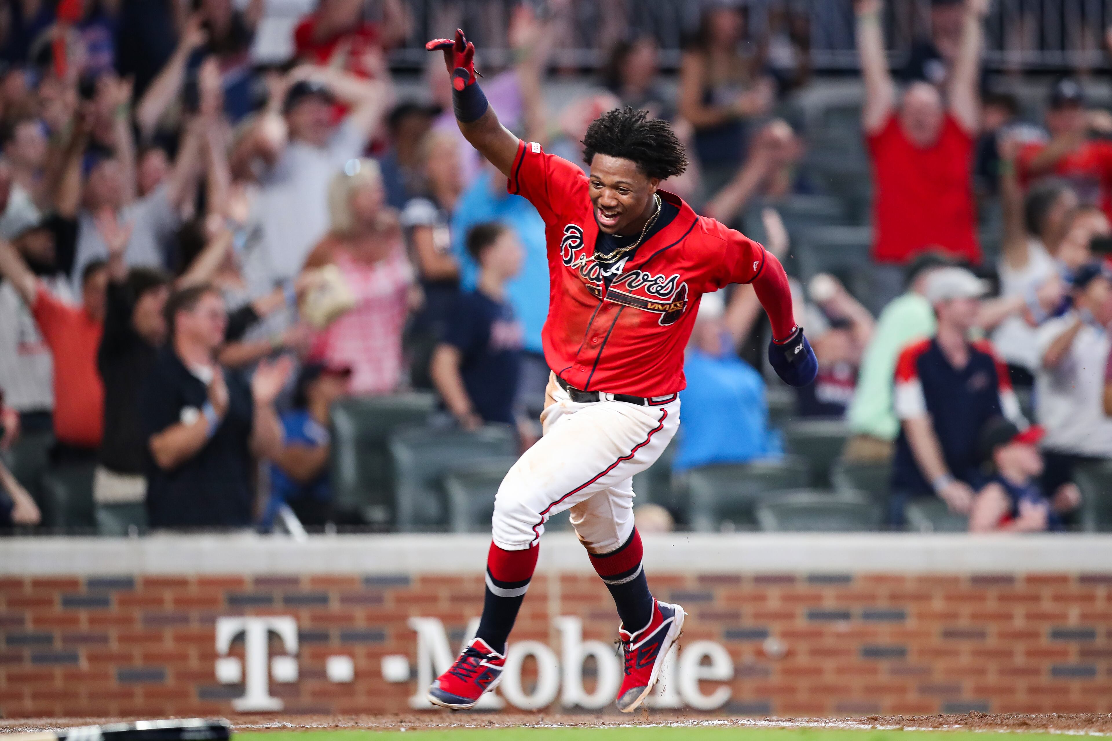 Ronald Acuna Jr. #13 scores on a single from Josh Donaldson #20 of the Atlanta Braves in the ninth inning during the game against the Washington Nationals at SunTrust Park on July 19, 2019 in Atlanta, Georgia. (Photo by Carmen Mandato/Getty Images)