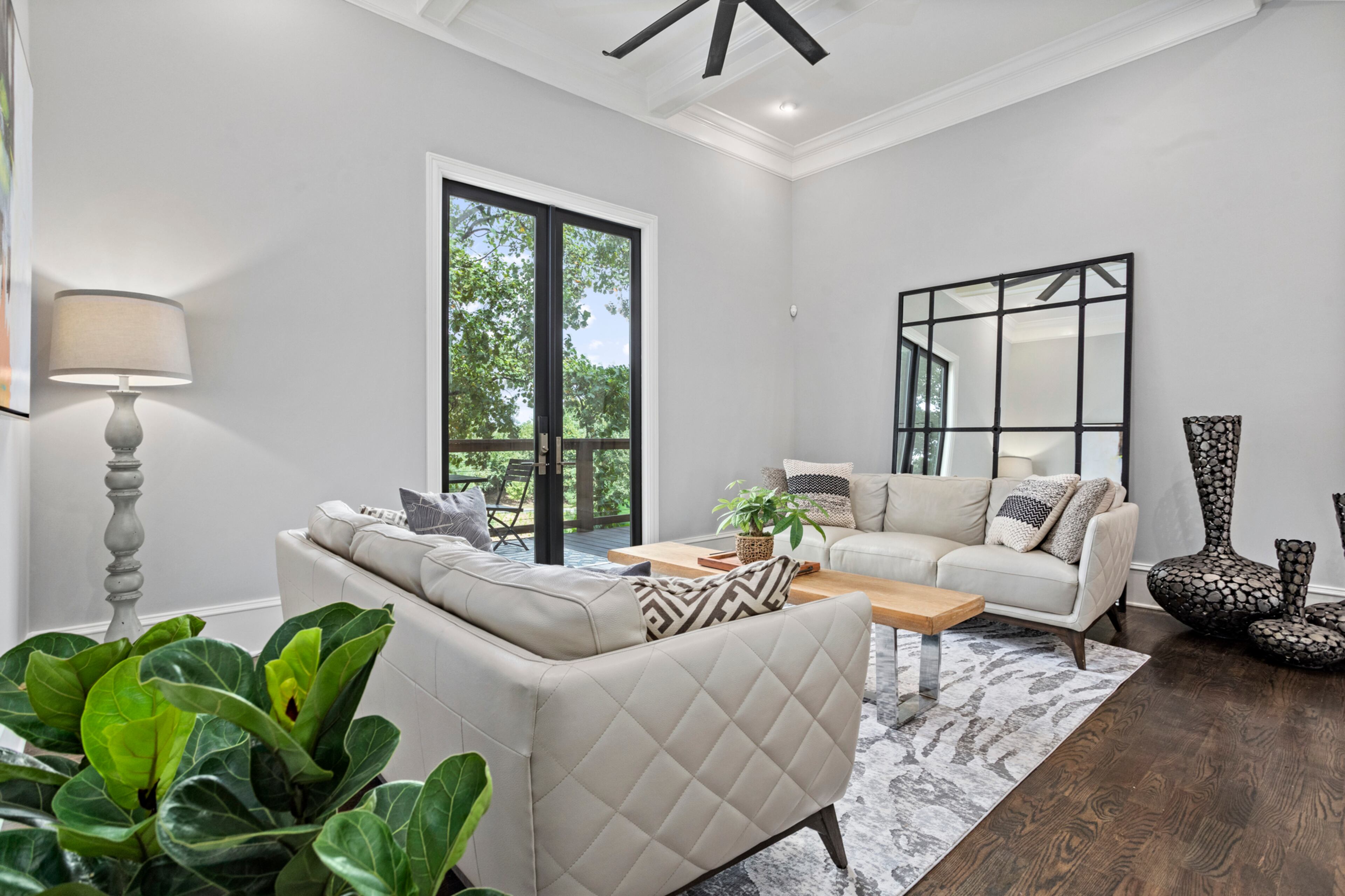 Bright living room with large doors to rear deck. Text by Justin Longenbach