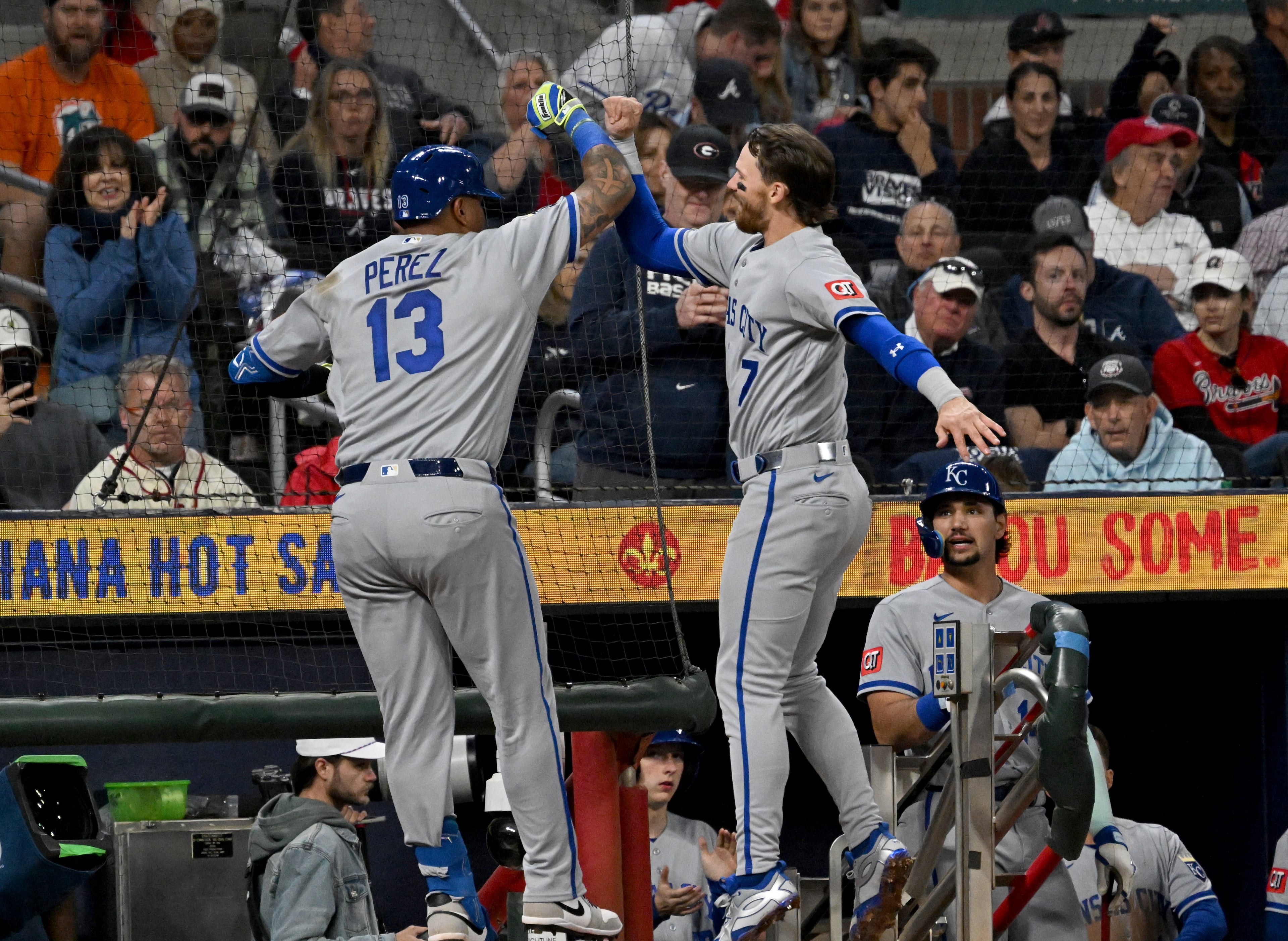 Kansas City Royals catcher Salvador Perez (13) celebrates with Kansas City Royals shortstop Bobby Witt Jr. (7) after hitting one run home run during the seventh inning of a baseball game at Truist Park, Saturday, March 28, 2026, in Atlanta. Atlanta Braves Dominic Smith hit a grand slam during the 9th inning to win 6-2 over Kansas City Royals. (Hyosub Shin/AJC)