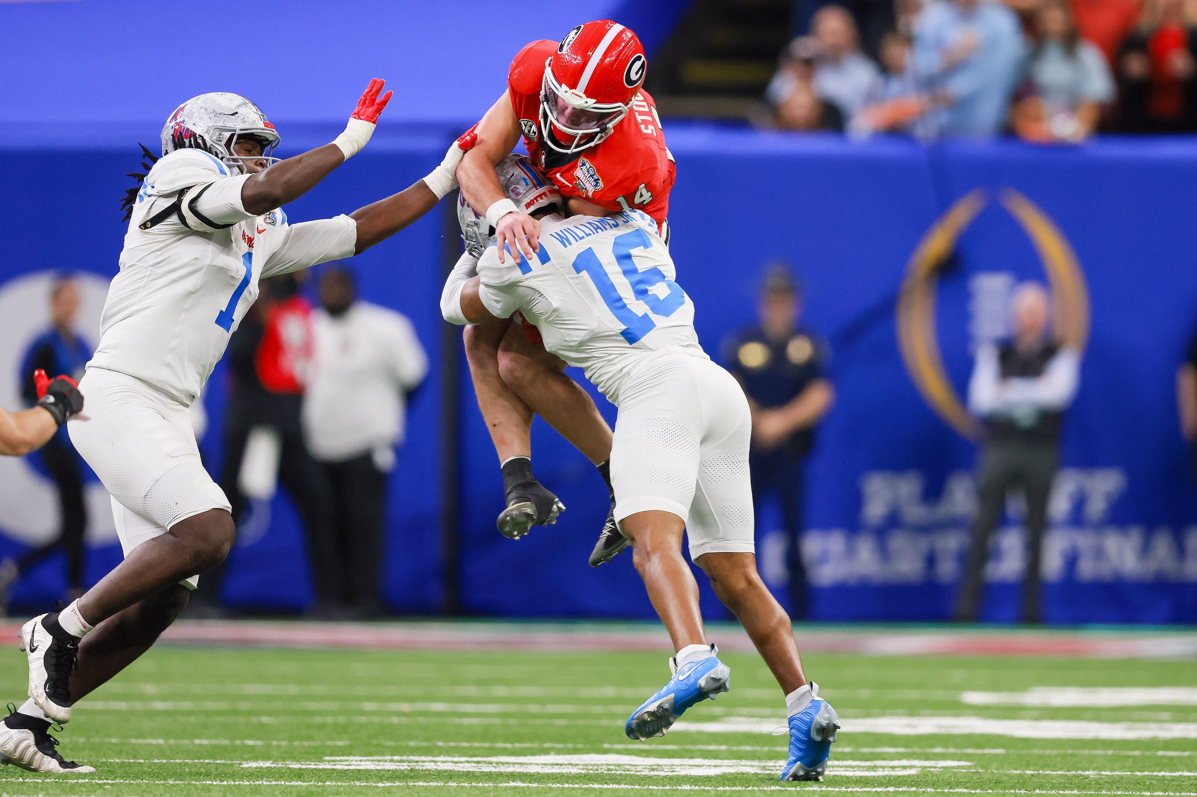 Georgia Bulldogs quarterback Gunner Stockton (14) is pressured by Ole Miss Rebels safety Wydett Williams Jr. (16) as he throws downfield during the third quarter of the College Football Playoff quarterfinal game at the Sugar Bowl in the Caesars Superdome, Thursday, Jan. 1, 2026, in New Orleans. (Jason Getz/AJC)