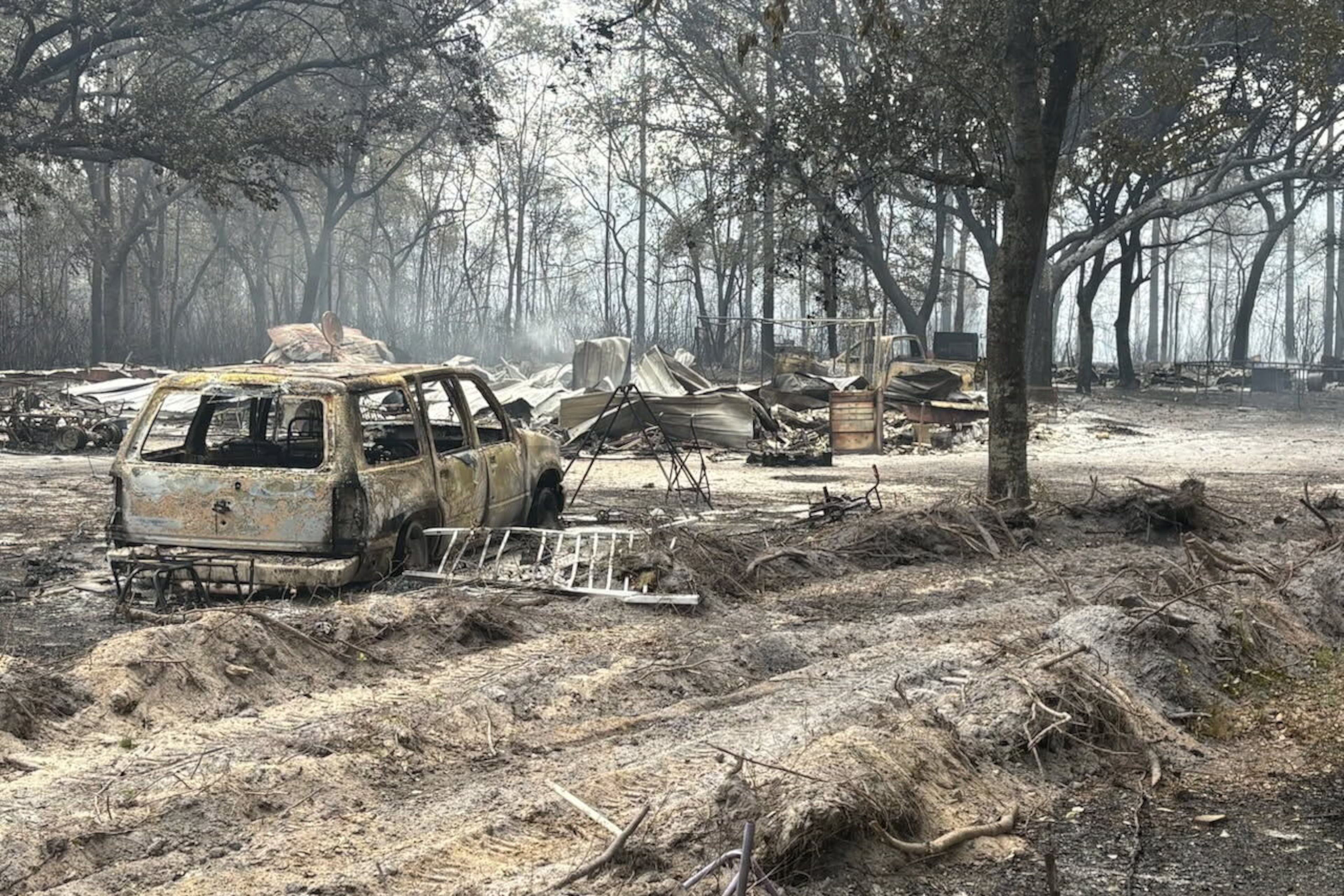 Burned vehicles and trees from the Pineland Road fire in southeast Georgia are seen on Wednesday, April 22, 2026. (Georgia Department of Natural Resources via AP)
