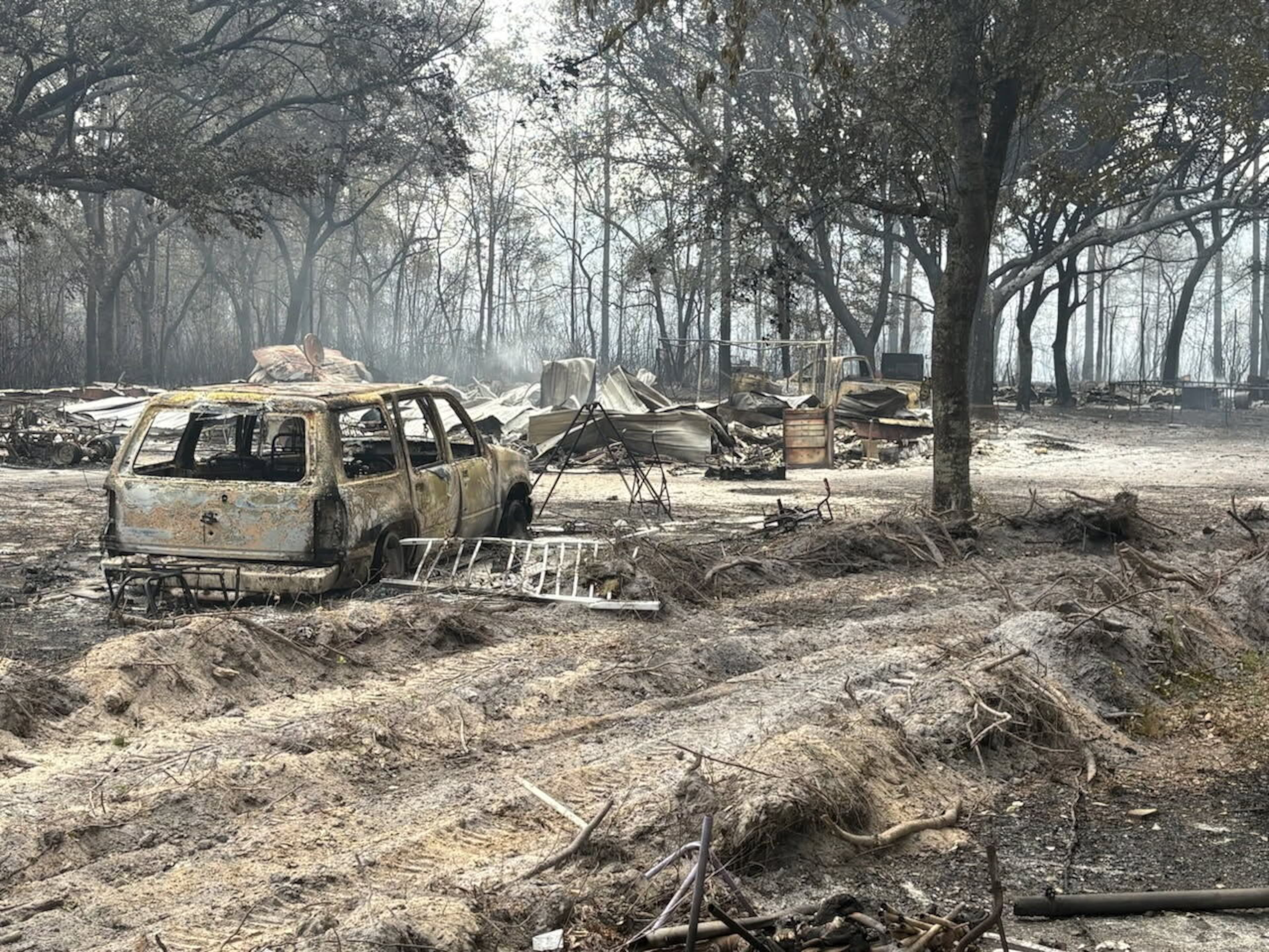 Burned vehicles and trees from the Pineland Road fire in southeast Georgia are seen on Wednesday, April 22, 2026. (Georgia Department of Natural Resources via AP)